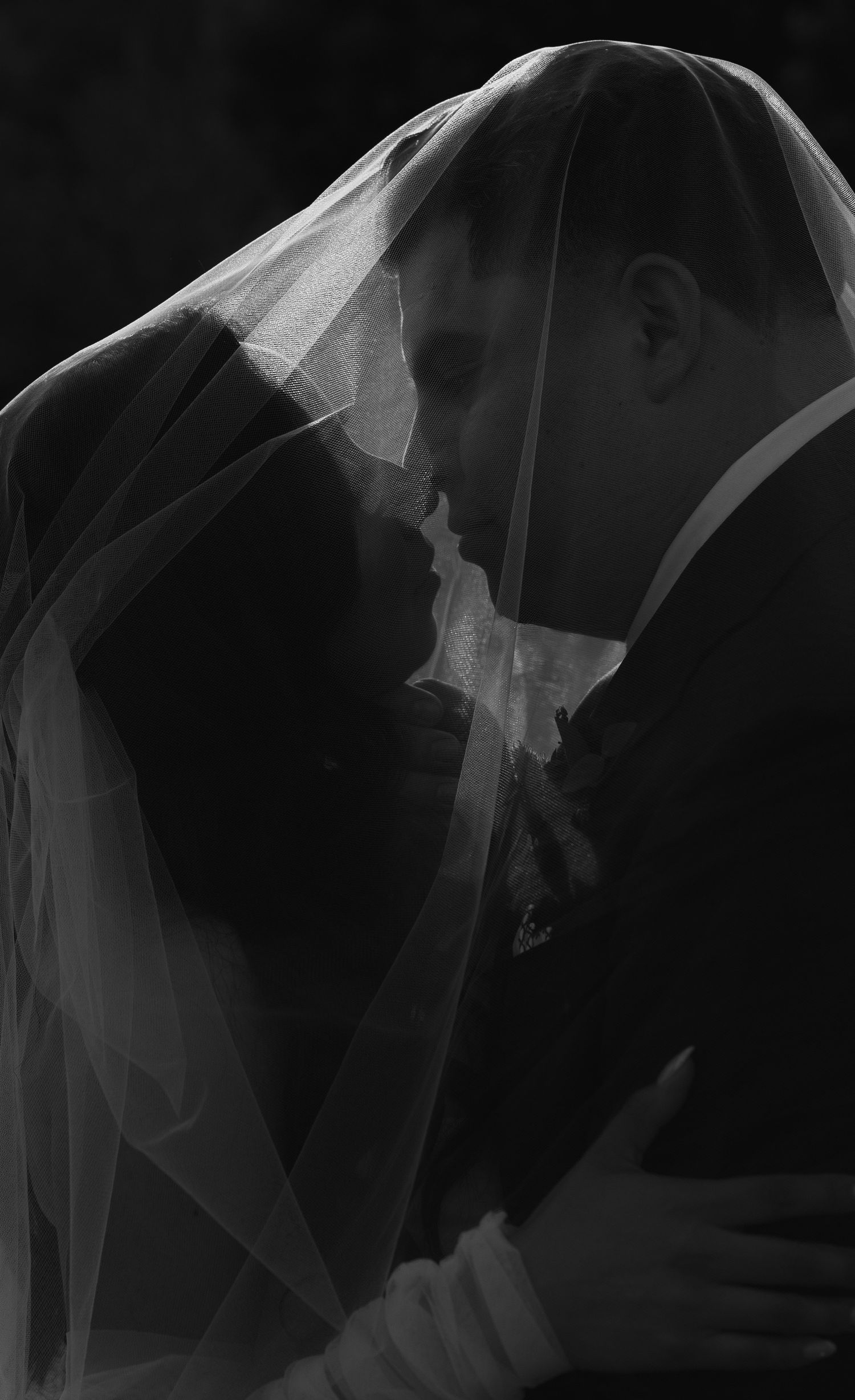 Abstract black and white images showing flowing wedding veil movement in dramatic lighting.