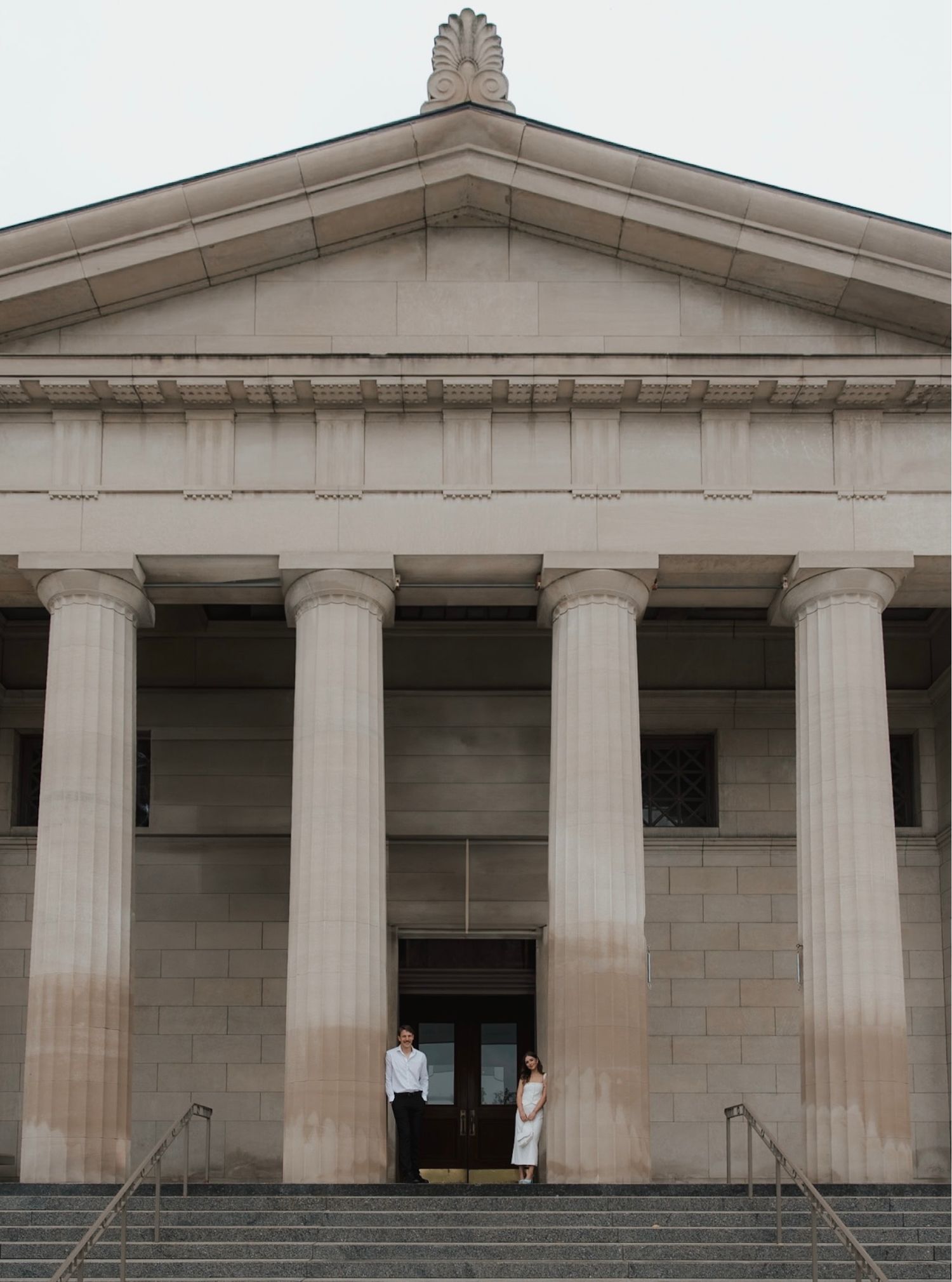 A neoclassical building facade with white columns stretching across the frame.