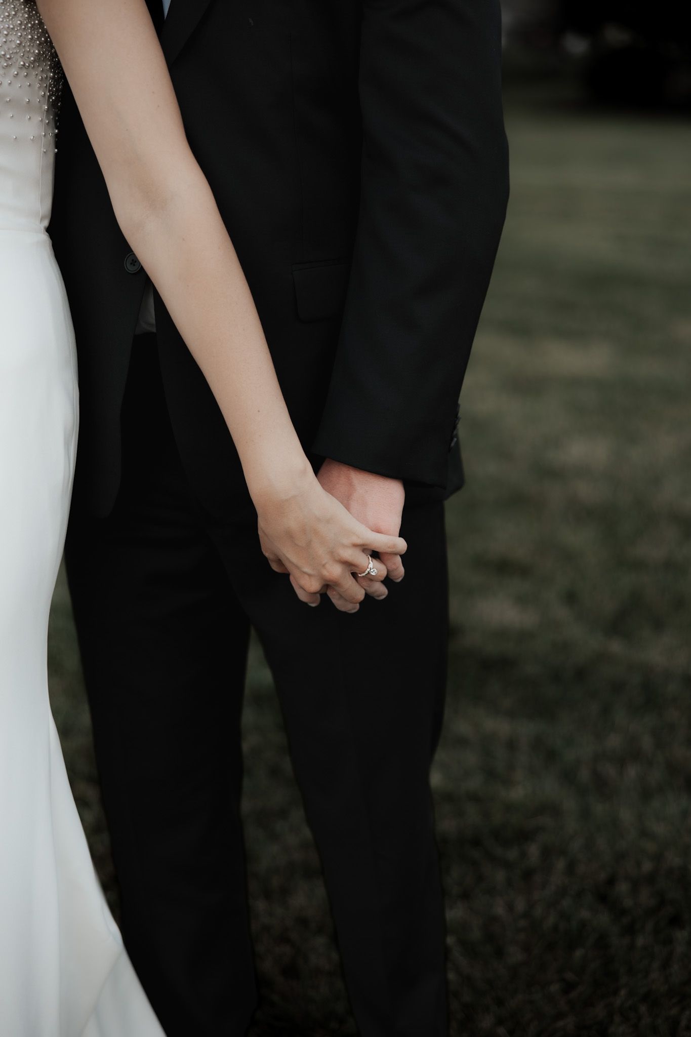 Detail shots of wedding attire showing white dress and black suit.