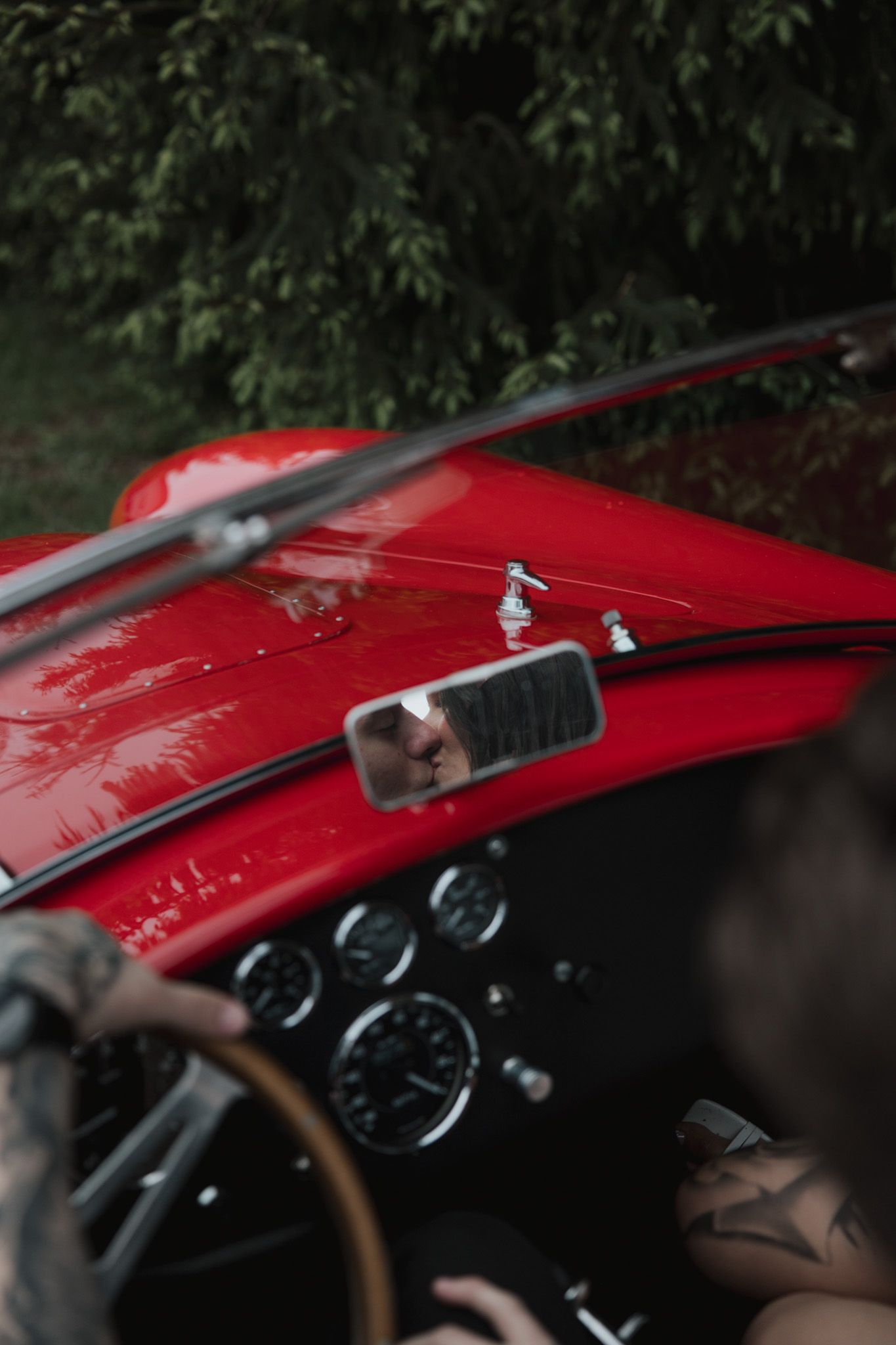Detail shot of a classic red sports car dashboard and interior.