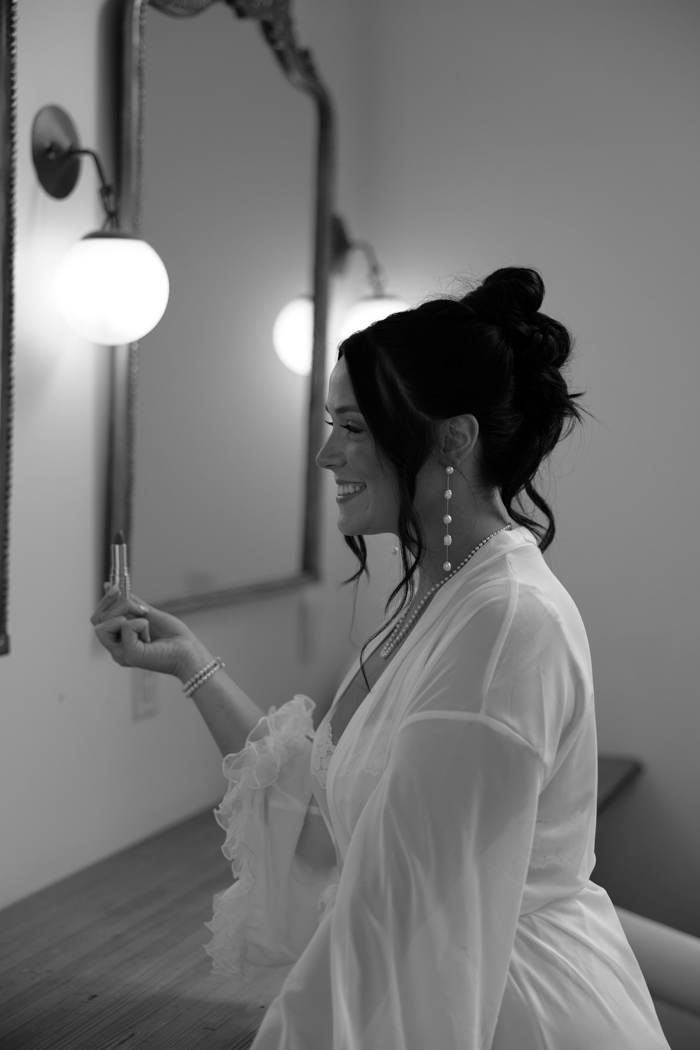A series of black and white photos showing joyful laughter and preparation moments in a white room.