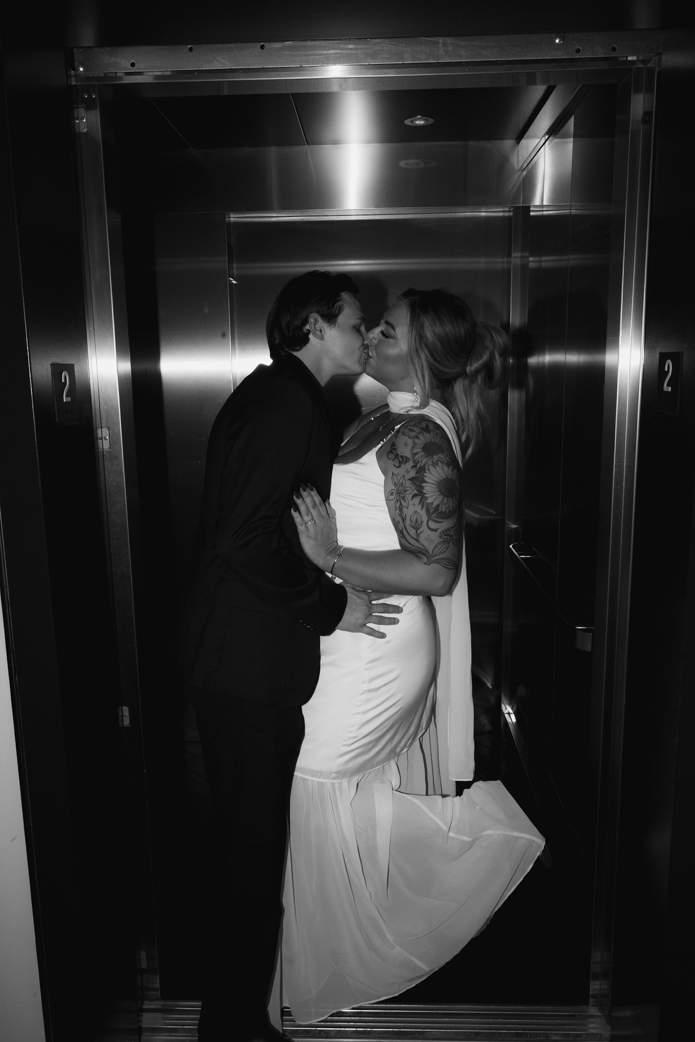 Dramatic black and white sequence of a romantic moment in an elevator.