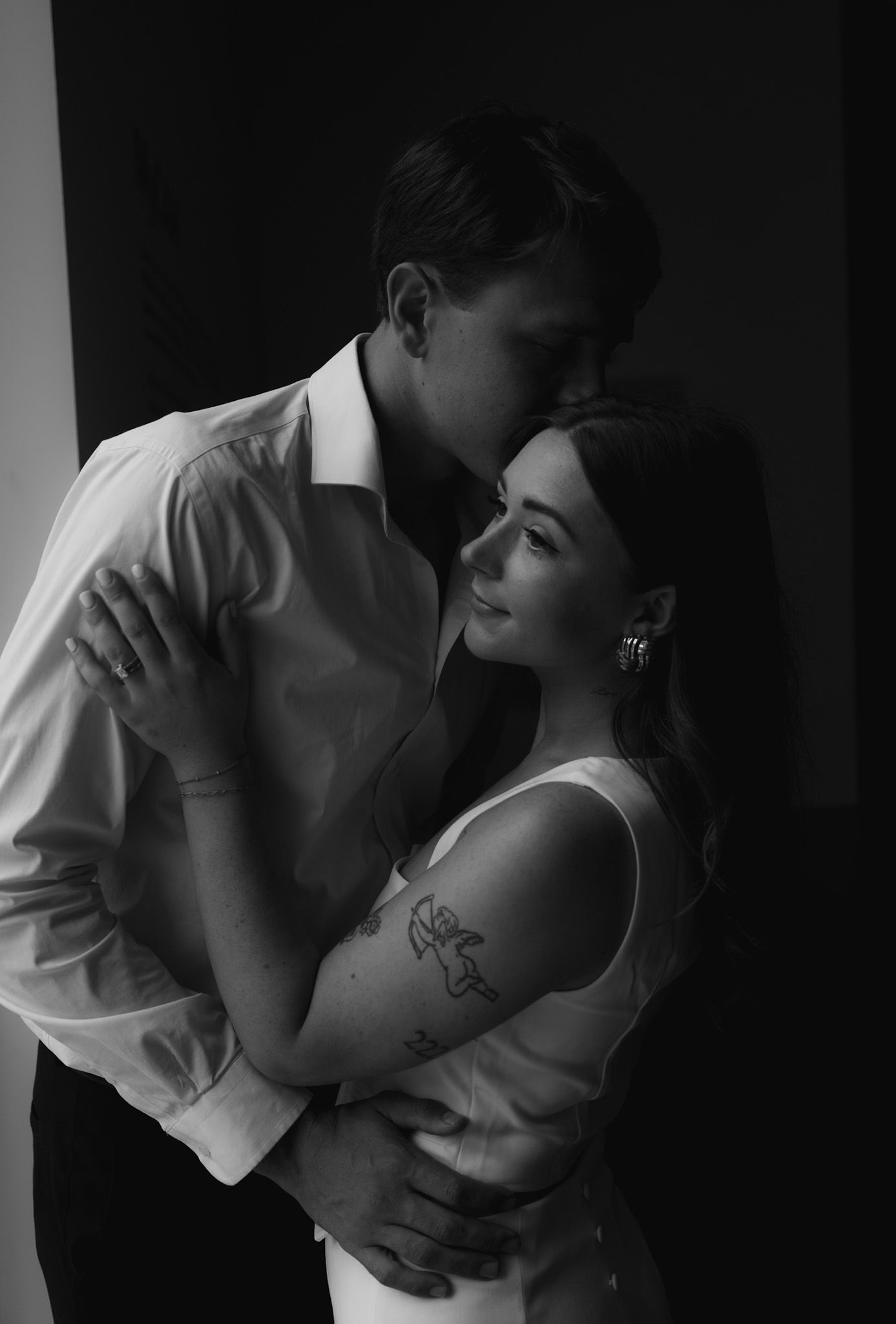 Intimate black and white romantic portraits captured in dramatic lighting.