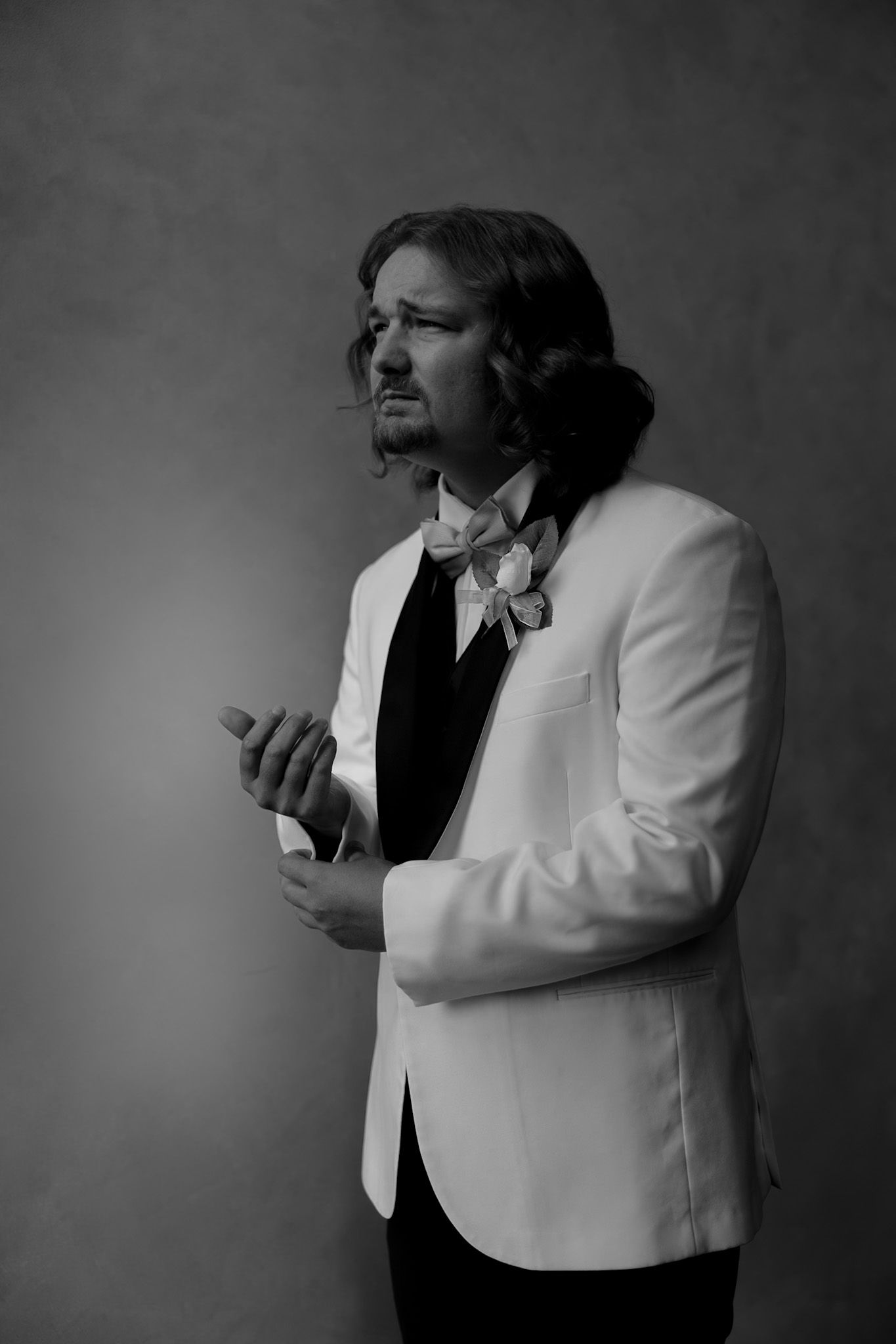 Dramatic black and white portrait showing emotional expressions against dark background.