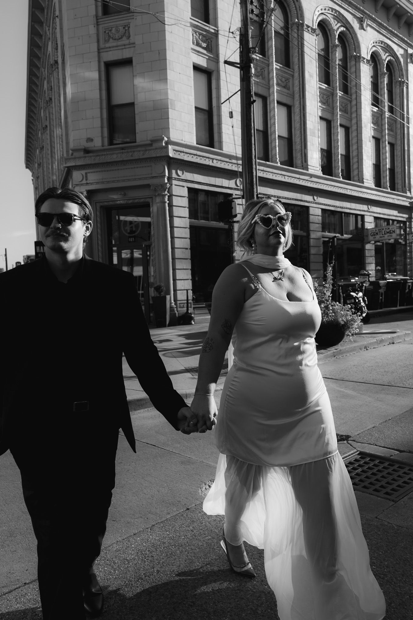 A romantic black and white sequence of a couple dancing together on a city street.