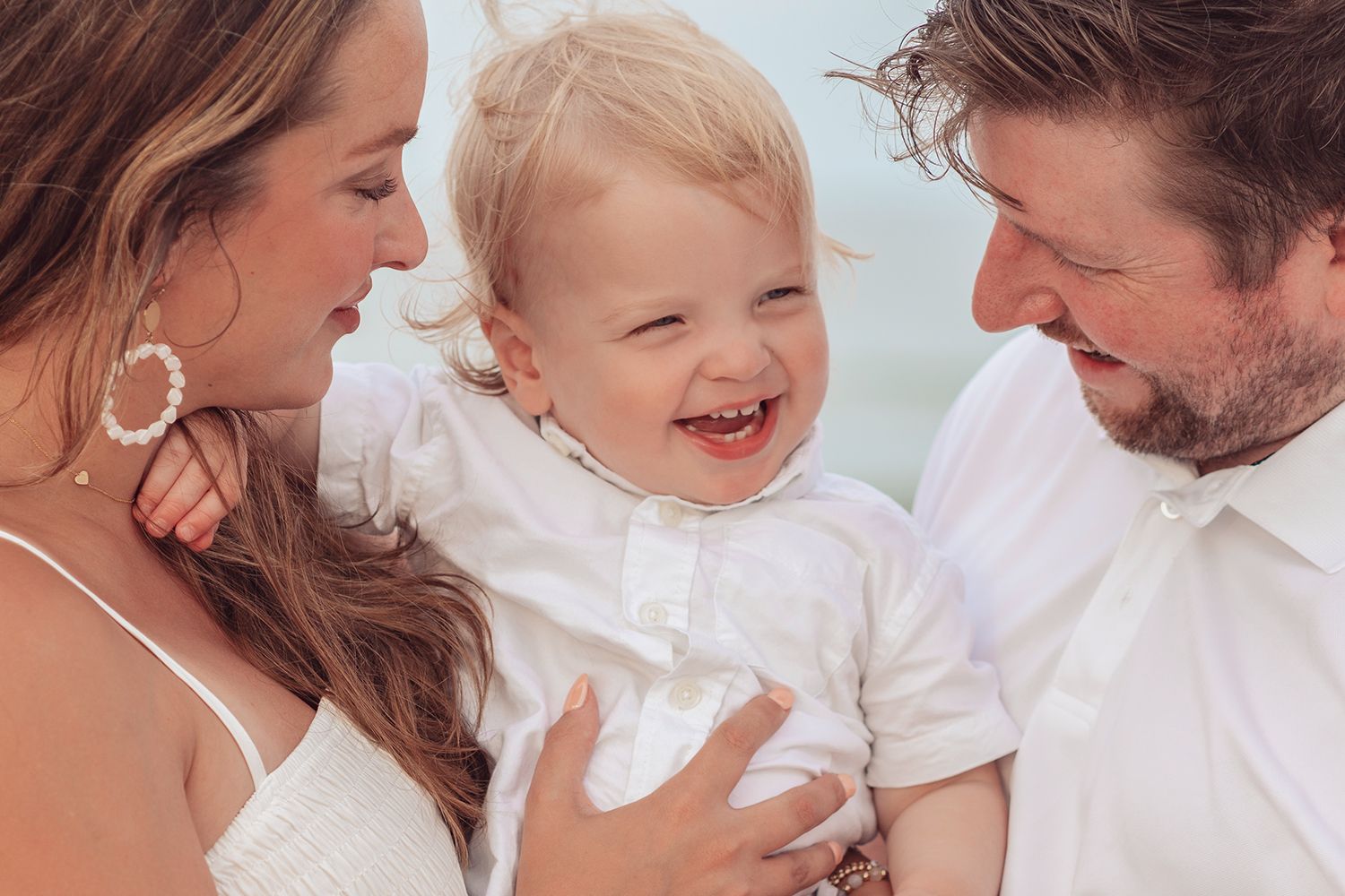 A happy family shares joyful moments together in a series of candid photos showing affection and laughter. on the beach in Jacksonville Fl