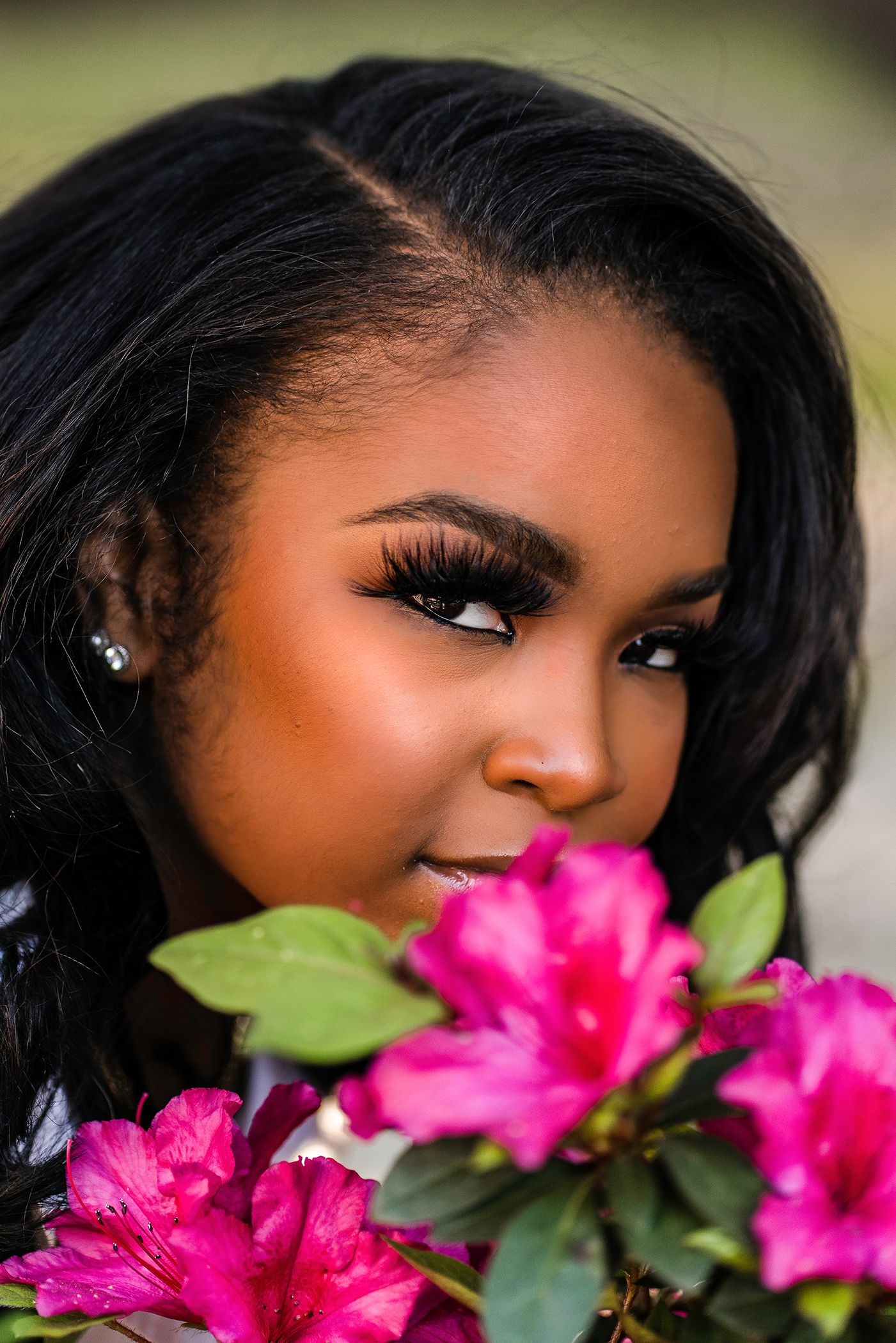 A close-up photos for high school senior photos with bright pink flowers showing artistic angles and vibrant floral elements in Jacksonville