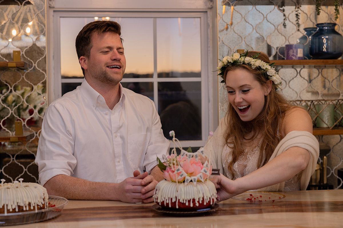 A couple sharing a romantic moment at a restaurant table with decorative lighting and ambiance.