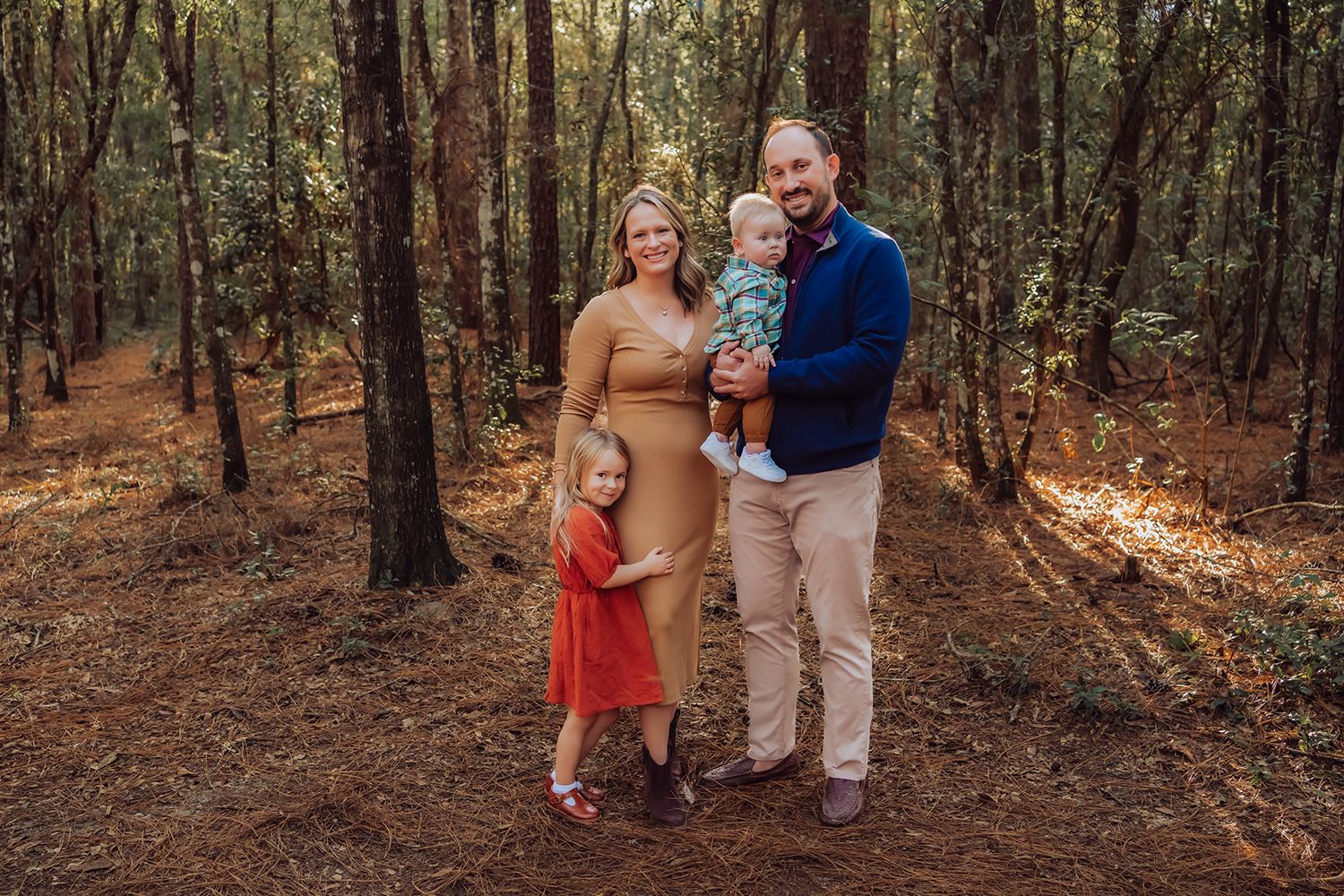 In a wooded autumn setting wearing casual attire for outdoor family photos in Gainesville Florida