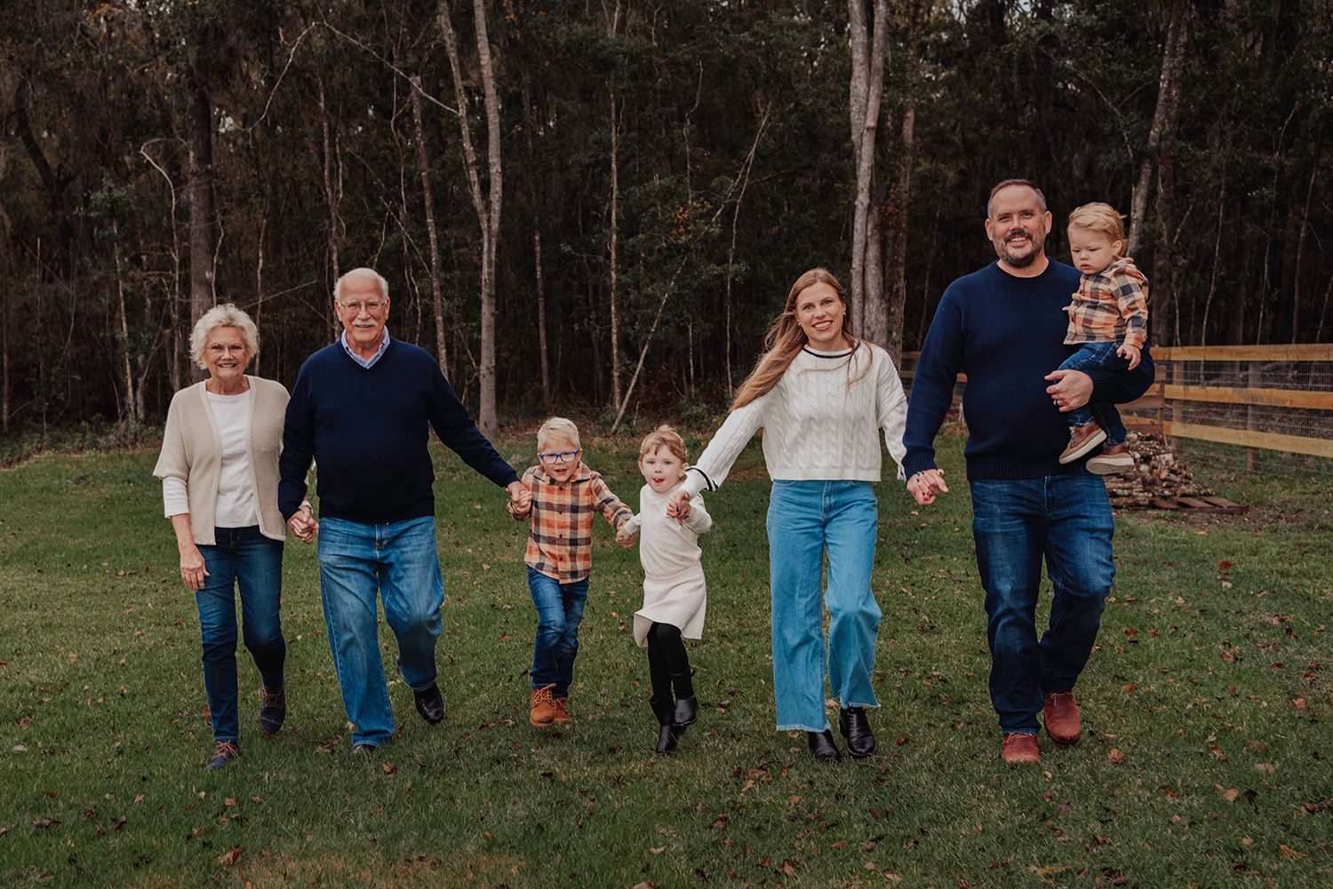 Candid family photos showing joyful moments together outdoors in casual attire for family photos in Gainesville Florida