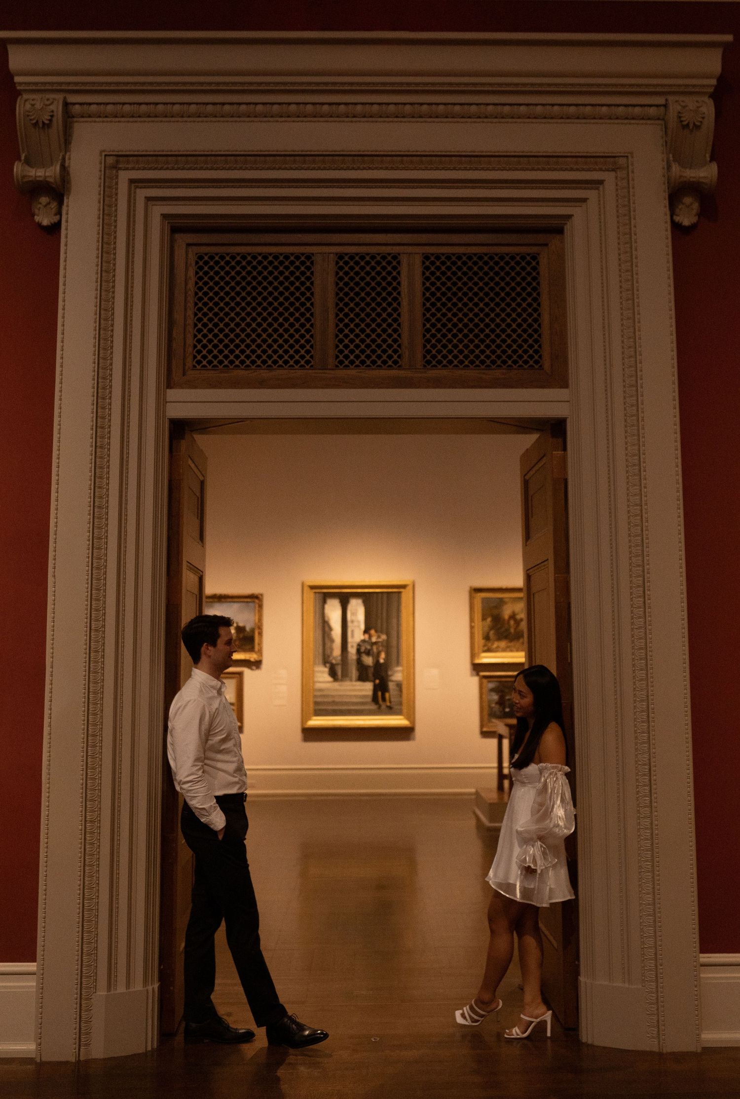 A series of artistic photographs showing silhouettes moving through an elegant museum gallery space.