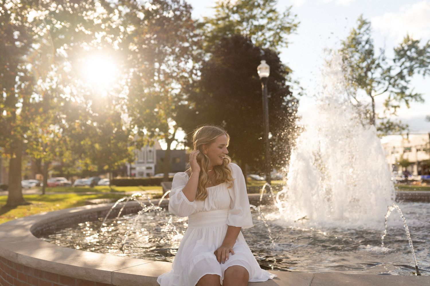 Sunlit water fountain creates a magical backlit scene with sparkling droplets.