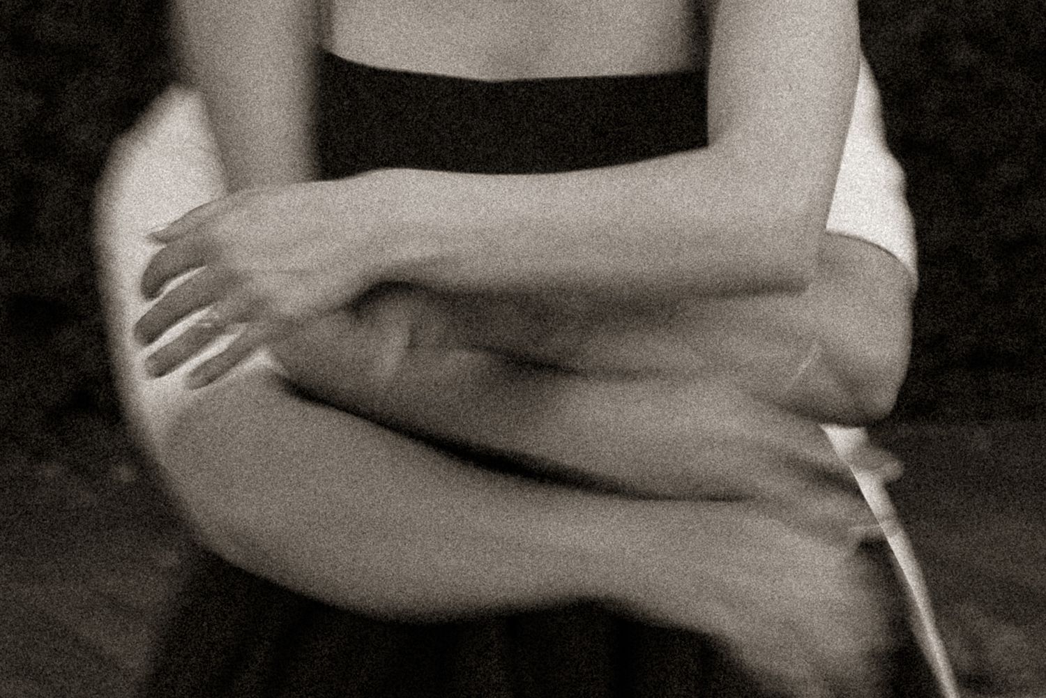 Silhouetted figures embracing in intimate close-up photography.