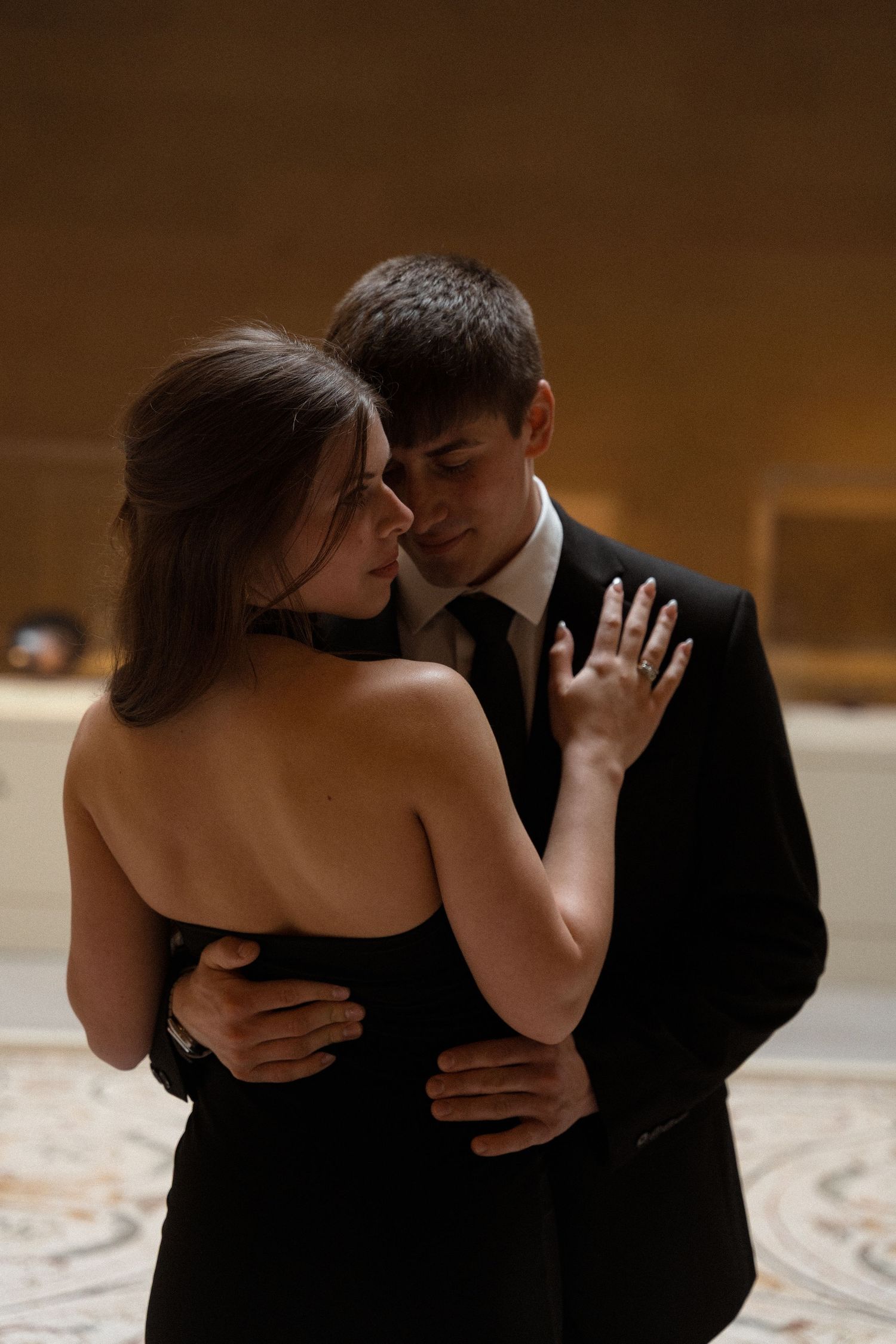 A romantic dance sequence unfolds in warm lighting against a museum backdrop.