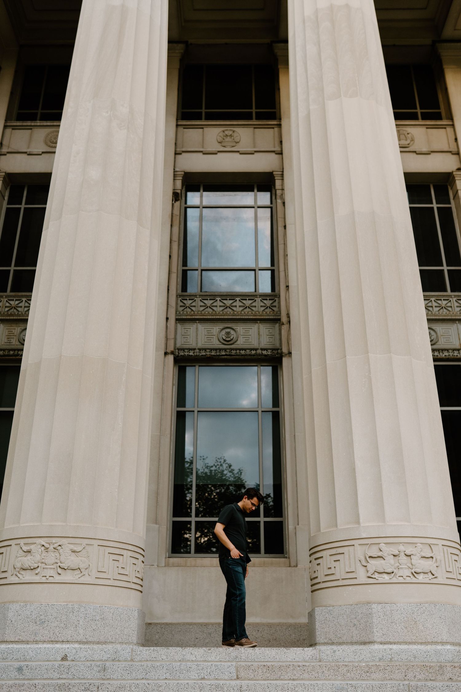 Classical white stone columns create dramatic architectural lines and shadows.
