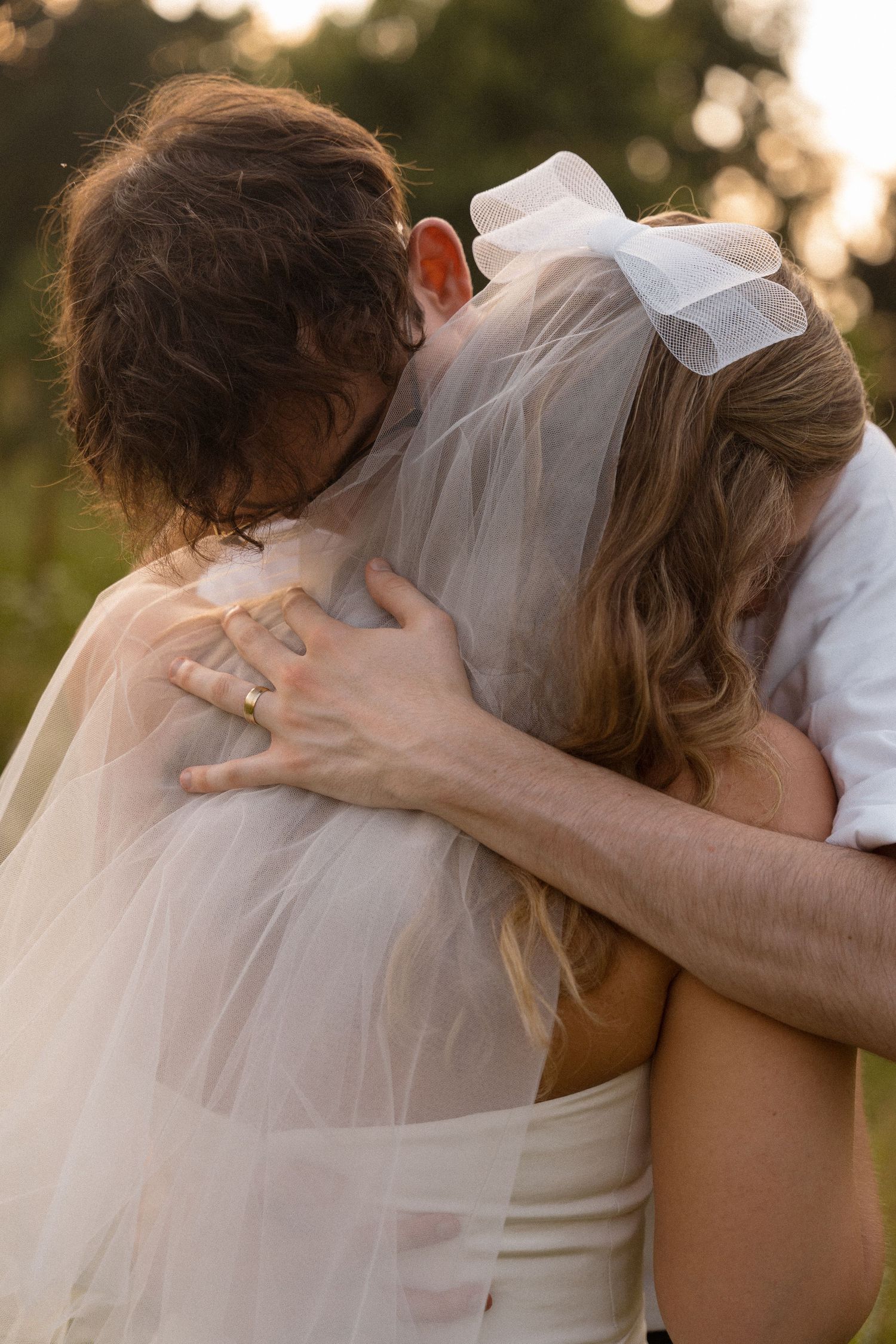 Intimate wedding portraits captured during golden hour with soft natural lighting.