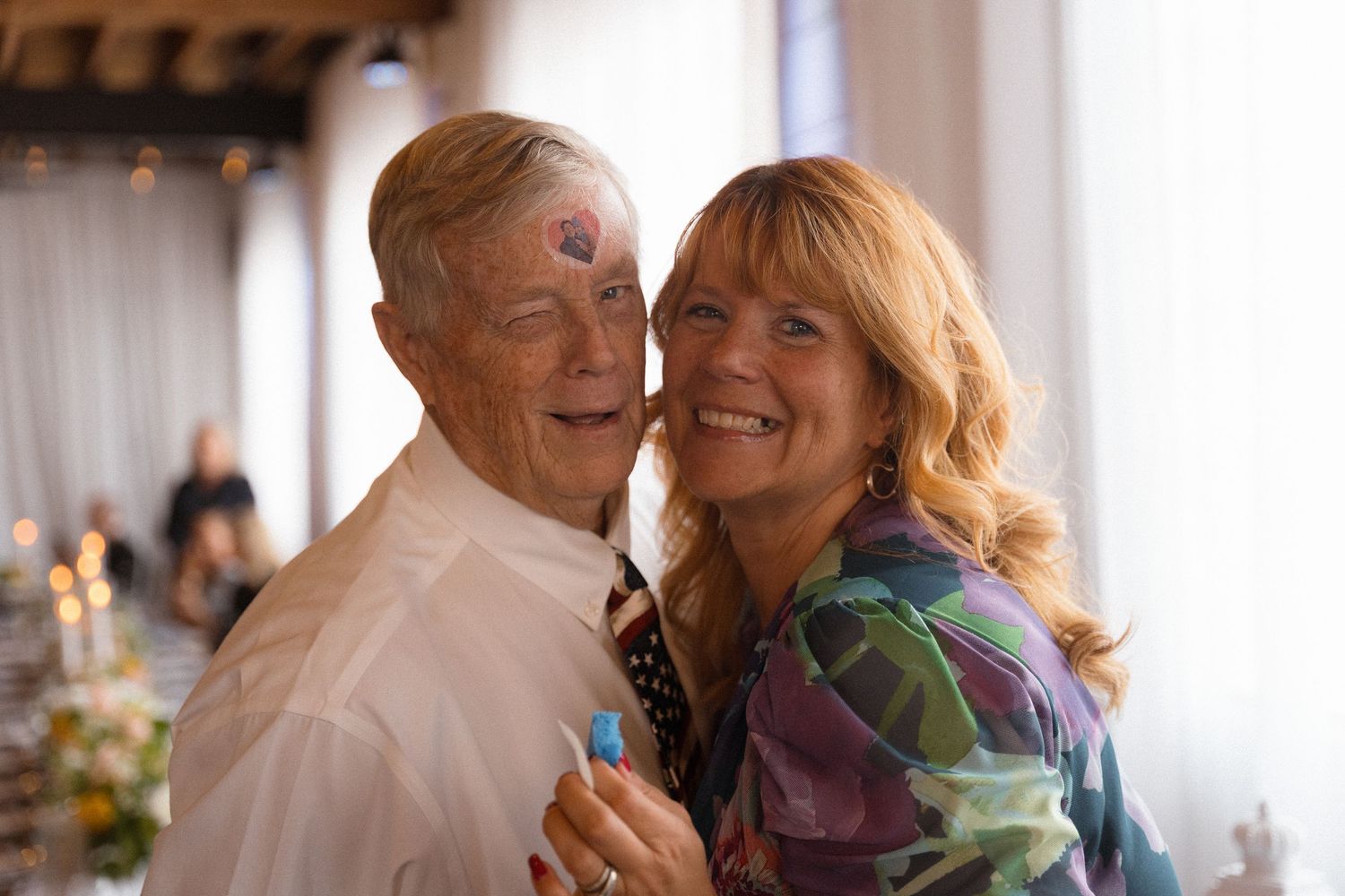Joyful couples dancing and embracing at a wedding celebration.