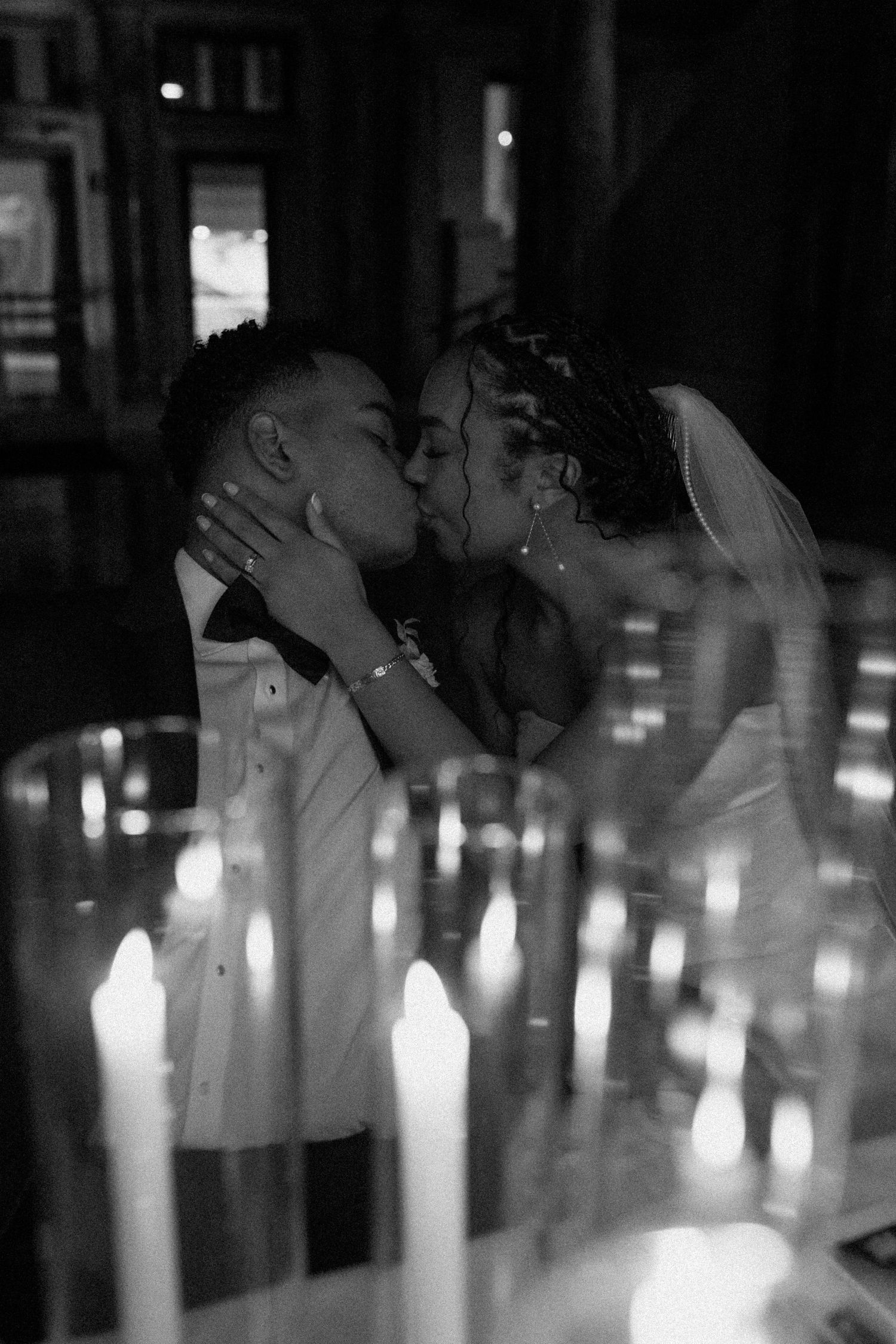 Silhouetted figures against glowing candlelight creating a romantic ambiance.