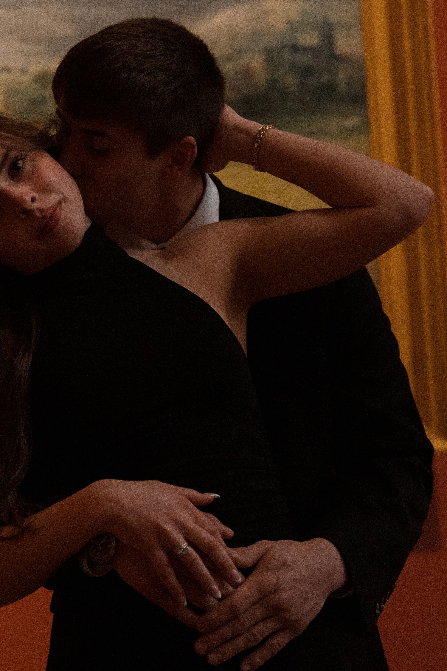 A romantic dance sequence unfolds in a museum gallery with warm lighting.