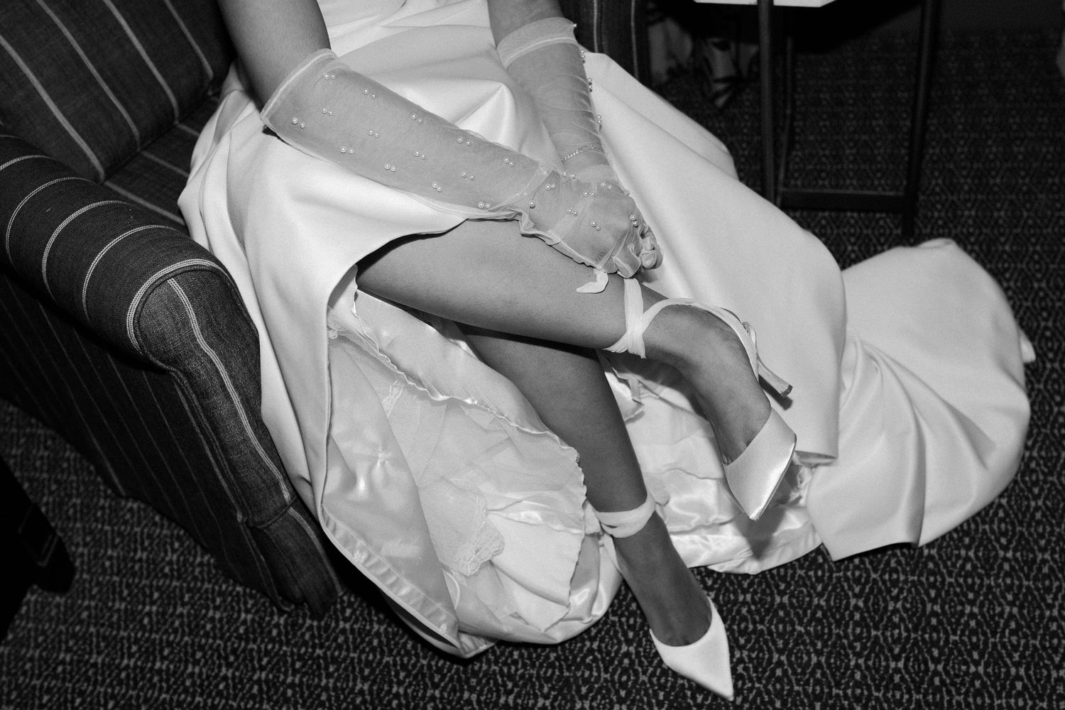 White fabric draped elegantly against a dark background in flowing patterns.