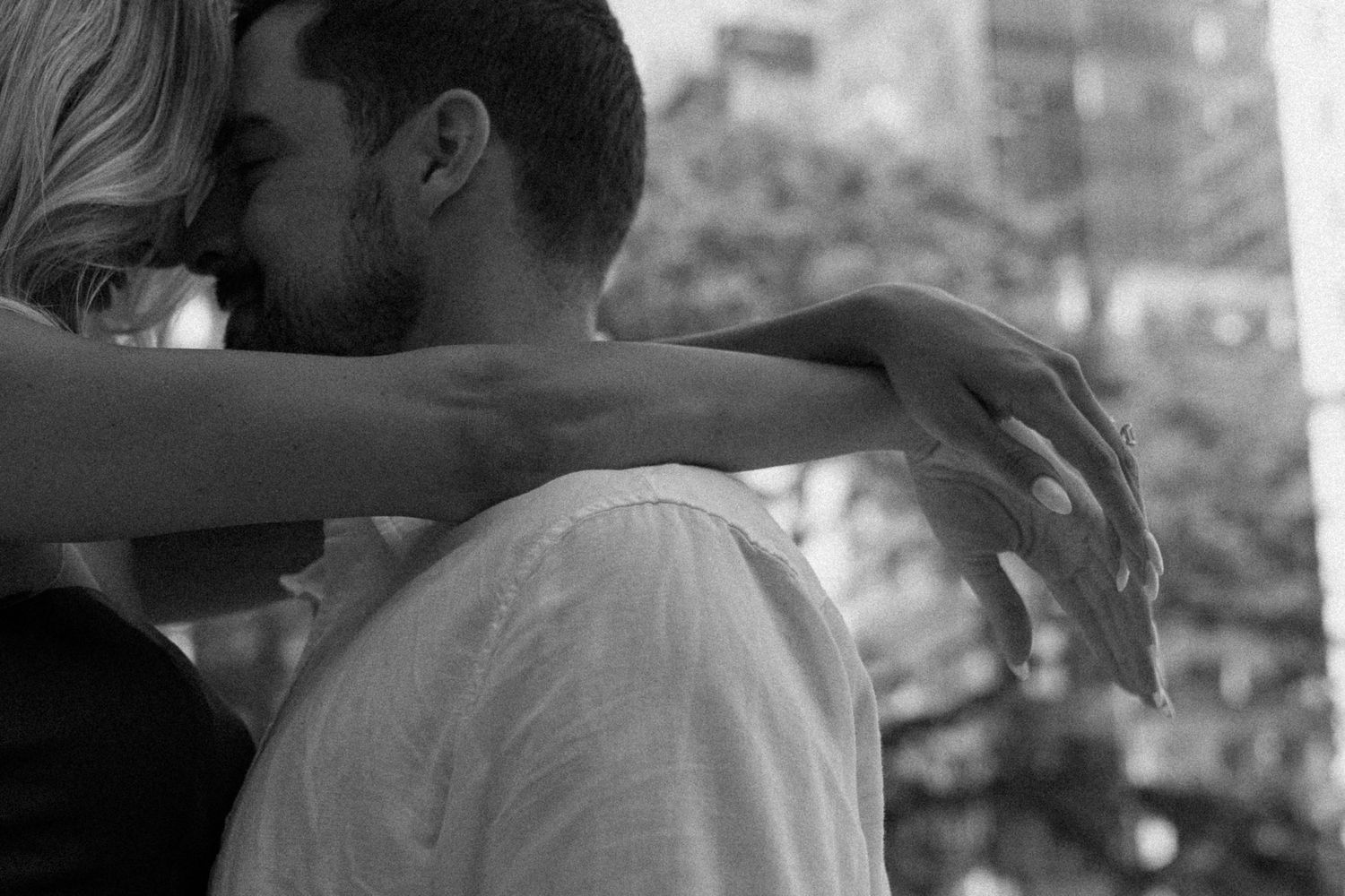 Black and white intimate portraits captured against an urban backdrop.