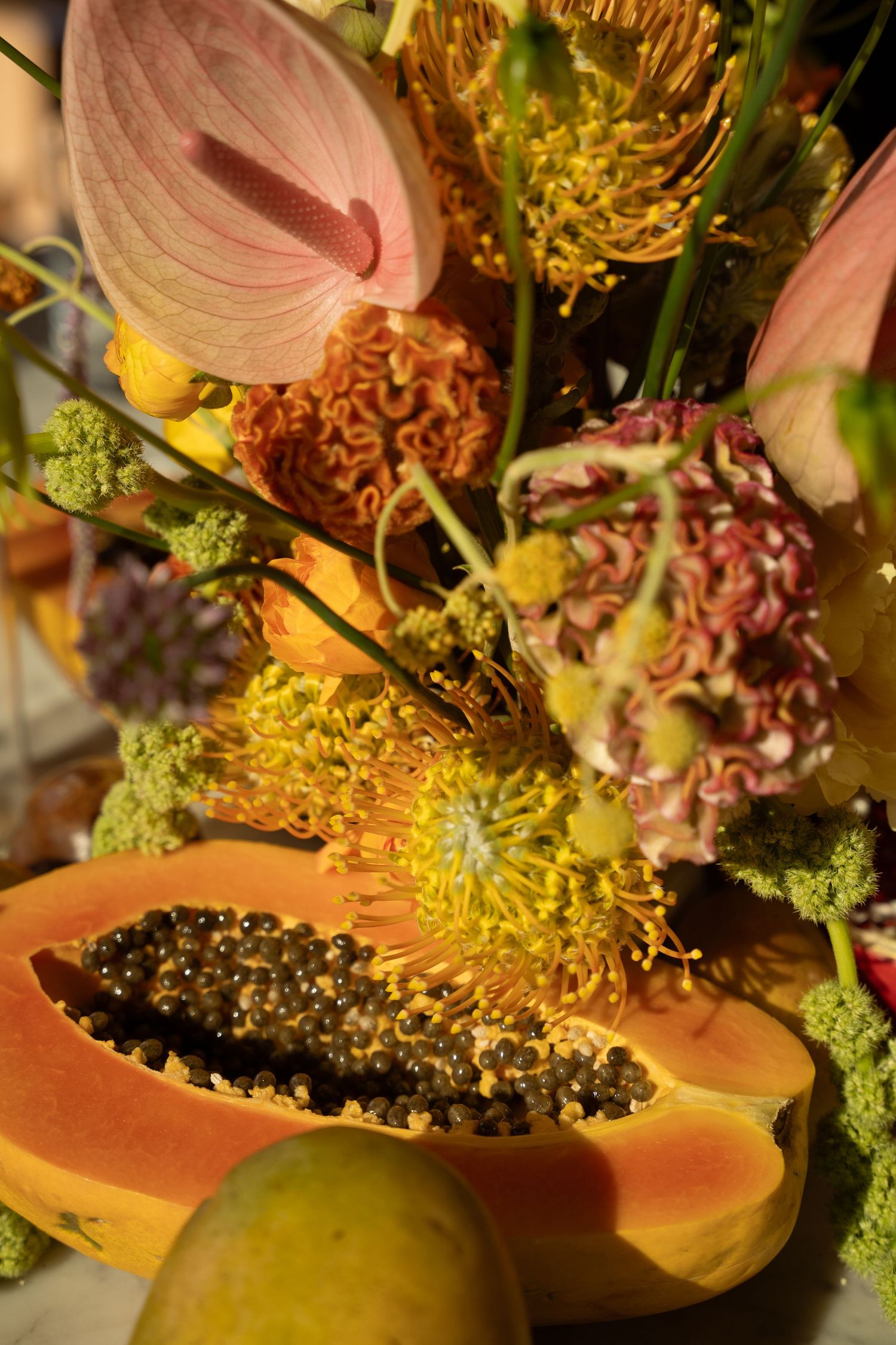 Close-up of tropical floral arrangements with pink and yellow blooms.
