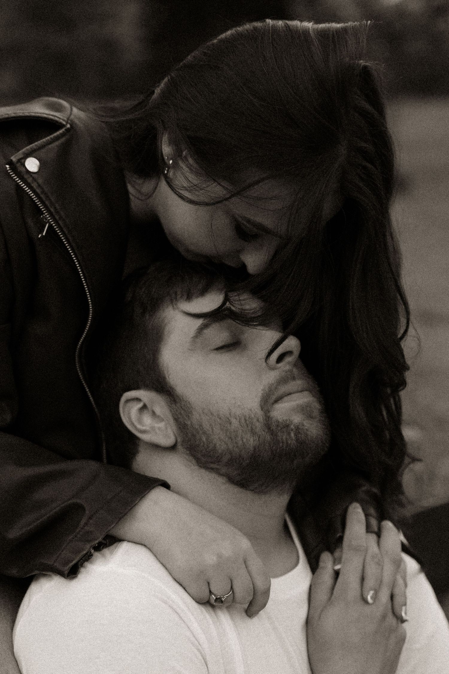 Intimate black and white portrait of a couple sharing a tender moment.