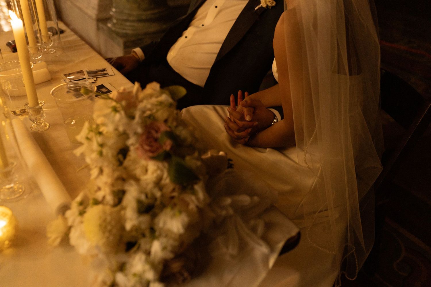 Romantic candlelit scene with white floral decorations creating an intimate atmosphere.