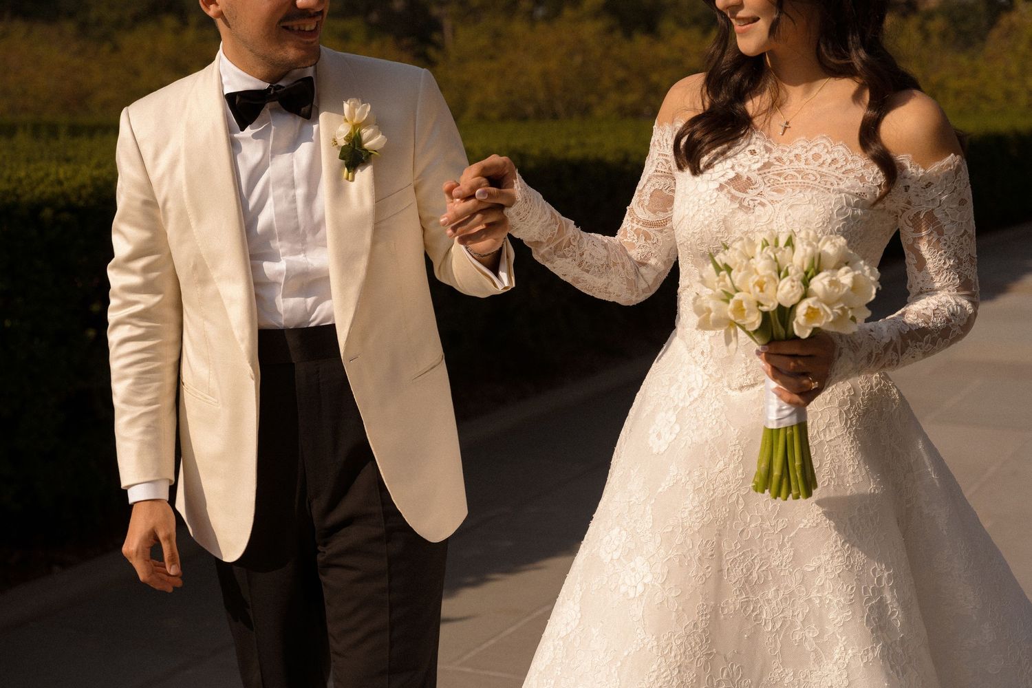Elegant wedding couple in formal attire sharing intimate moments during their celebration.