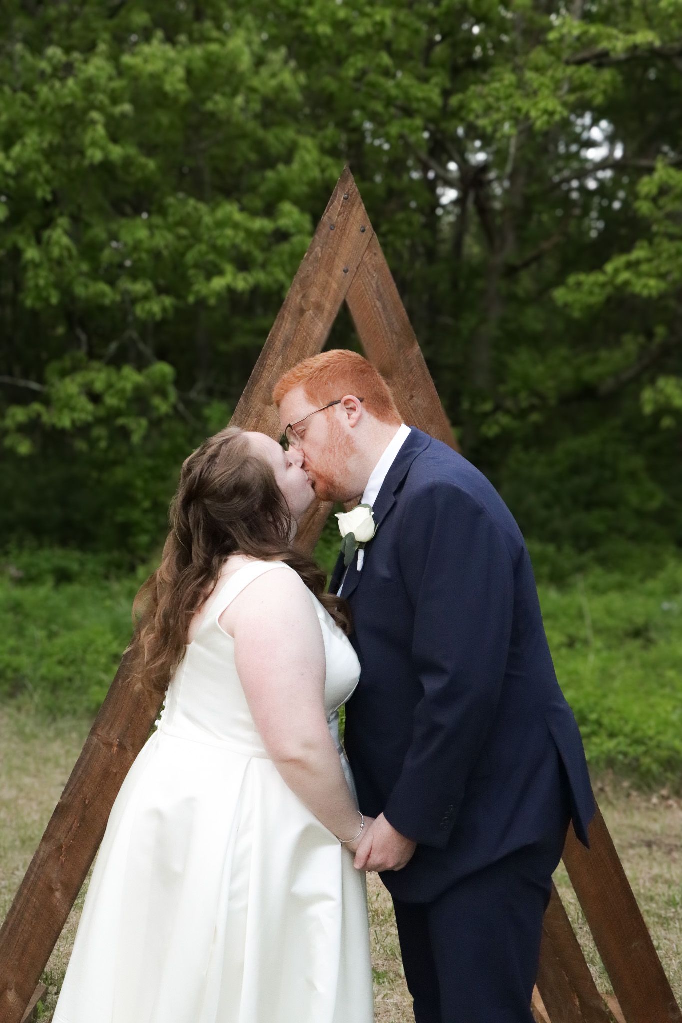 Bride and groom kiss during their intimate outdoor wedding ceremony in Massachusetts.