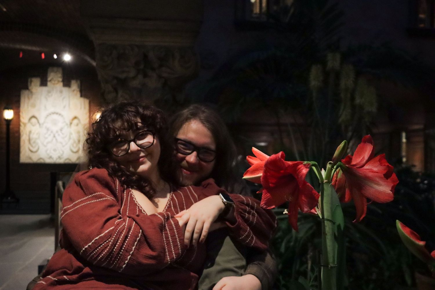 An intimate moment of a couple in a dimly lit romantic room of a Boston museum.