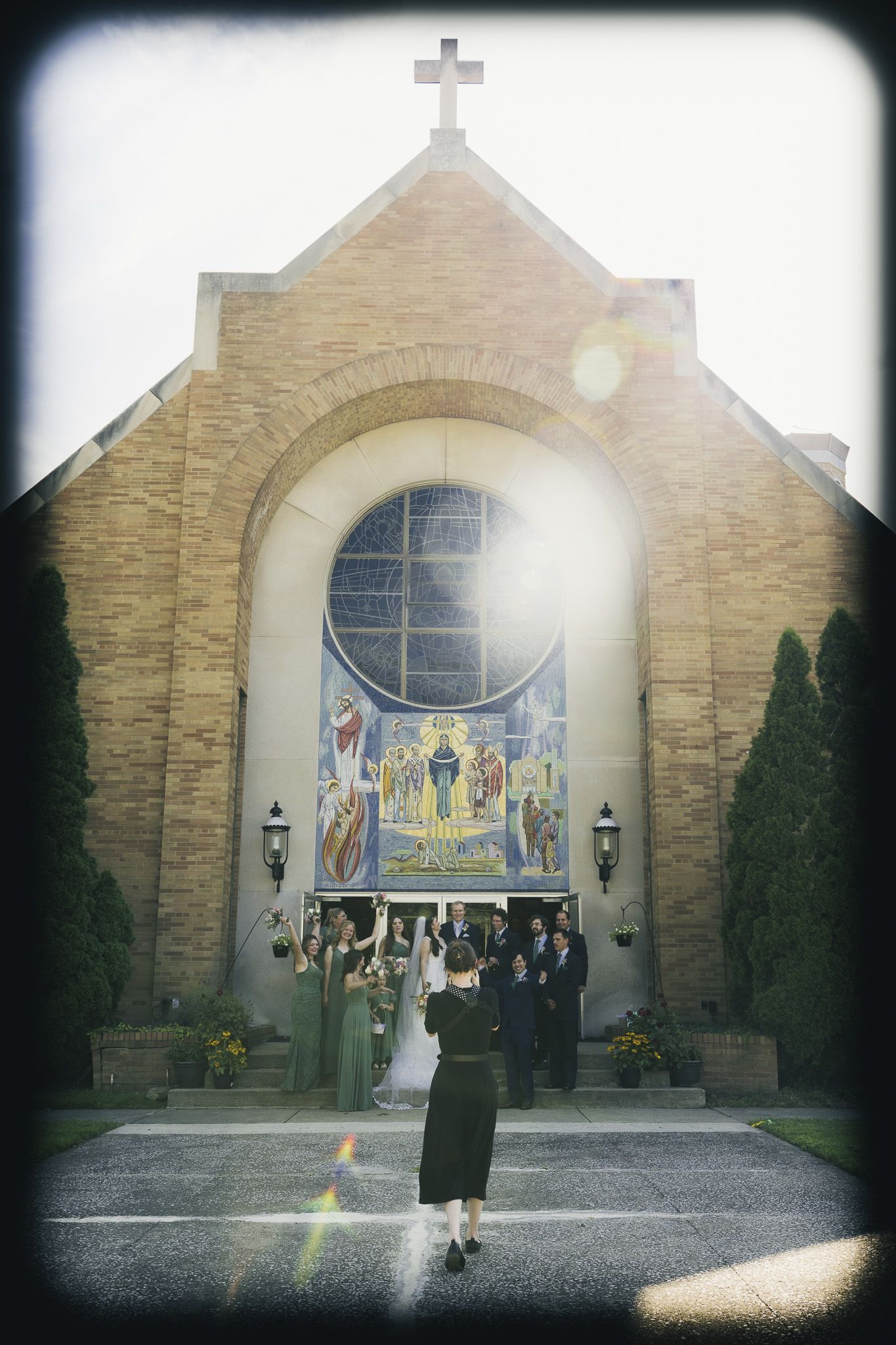 Stone church exterior with stained glass window and architectural details in vintage style.
