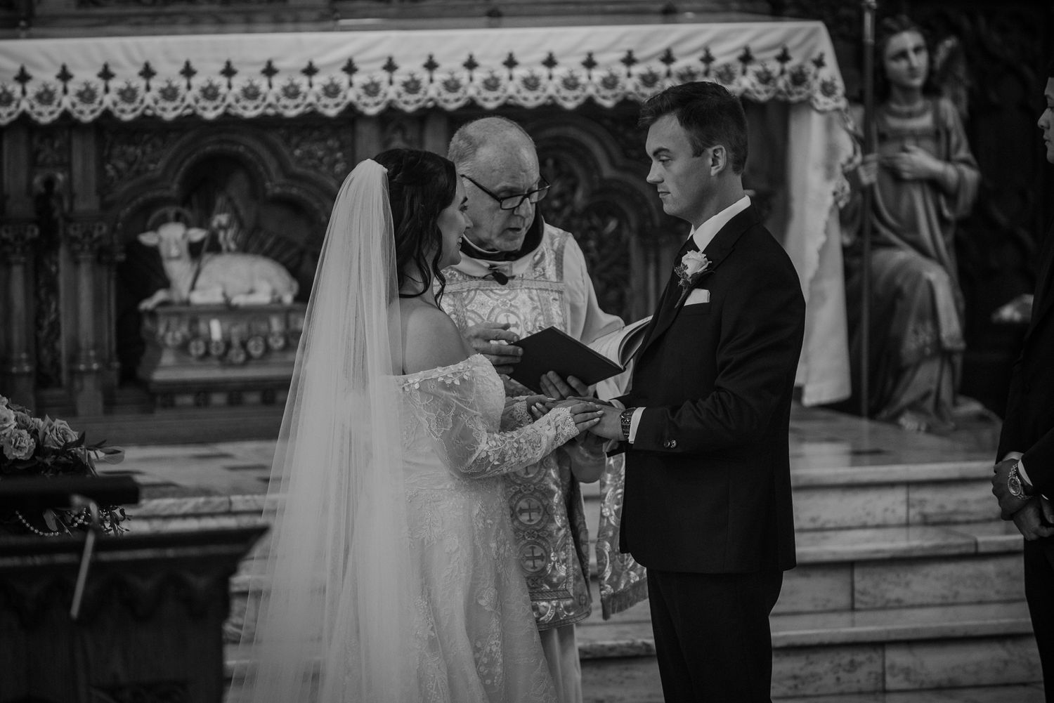 Wedding ceremony taking place at the altar of a traditional church.