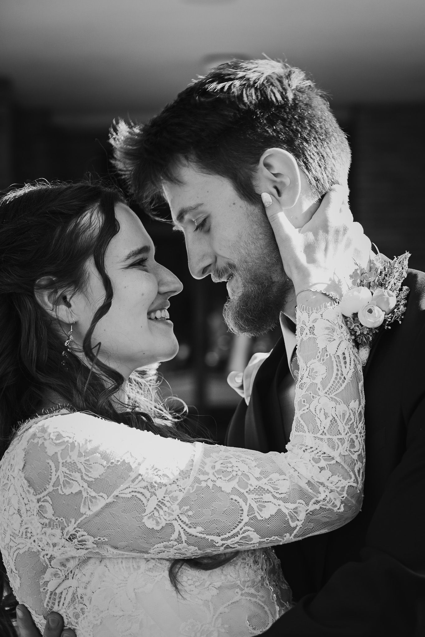 Intimate black and white portrait of newlyweds sharing a romantic moment.