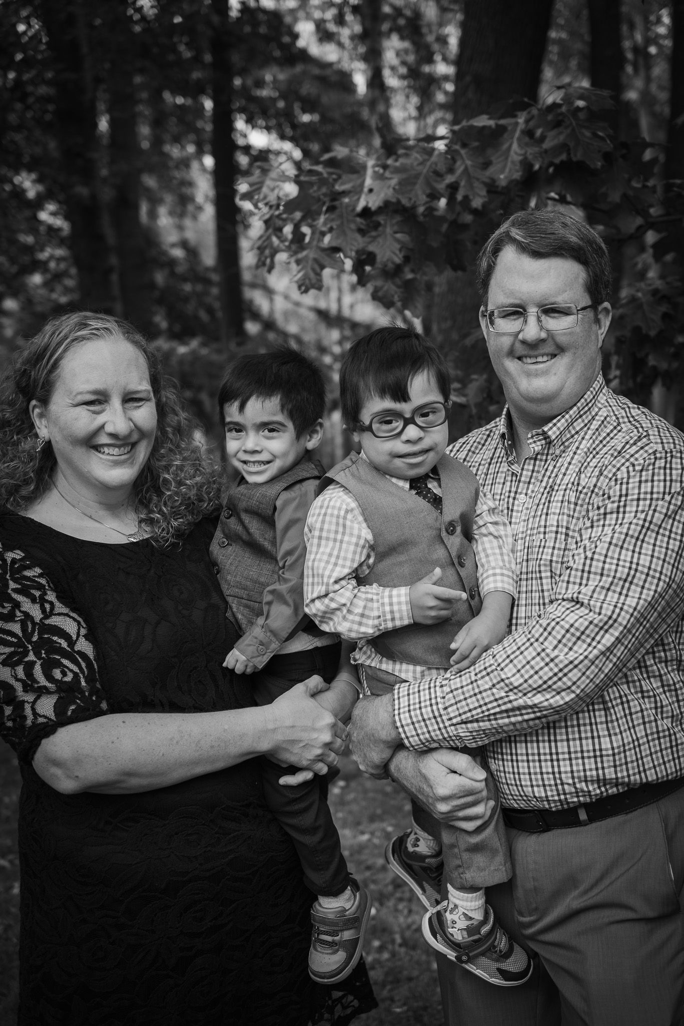 A playful family photo sequence captured in a wooded outdoor setting.