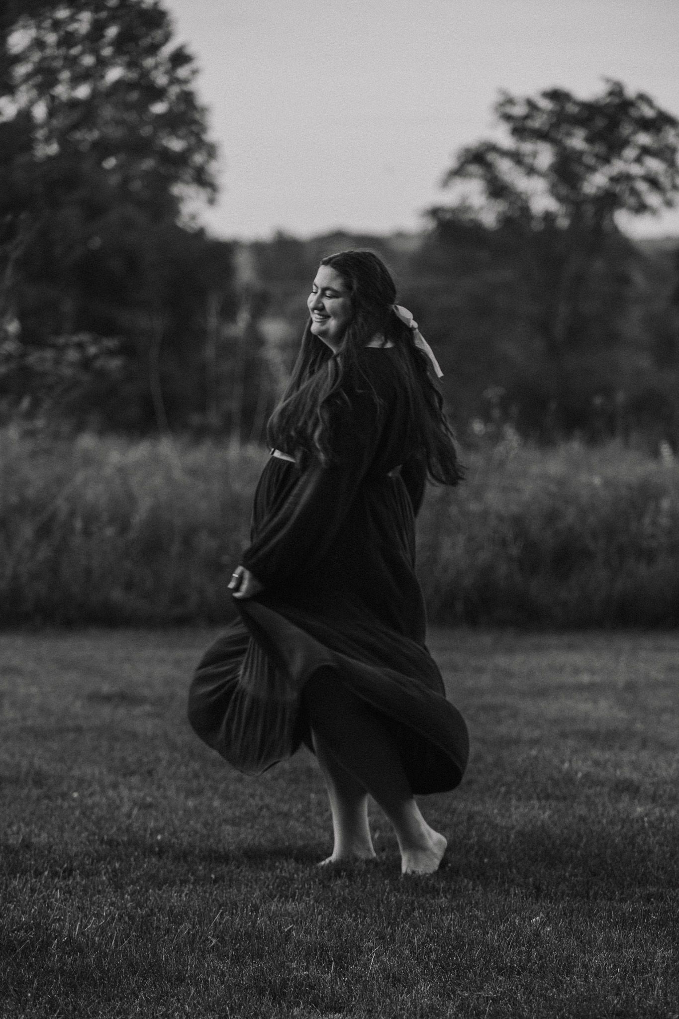 A black and white capture of dancing movement in a field.
