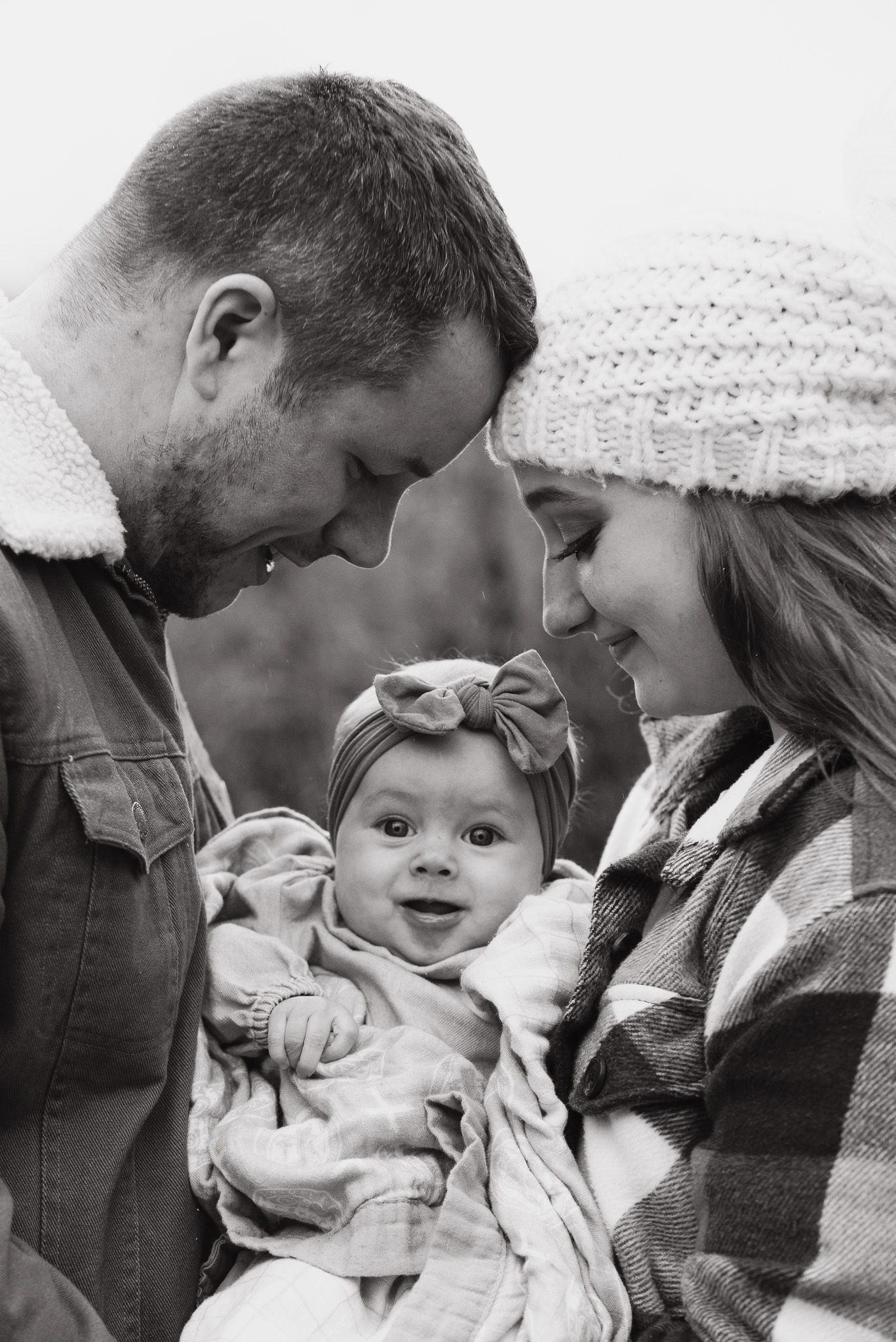 Family sharing tender moment together in cozy winter setting.