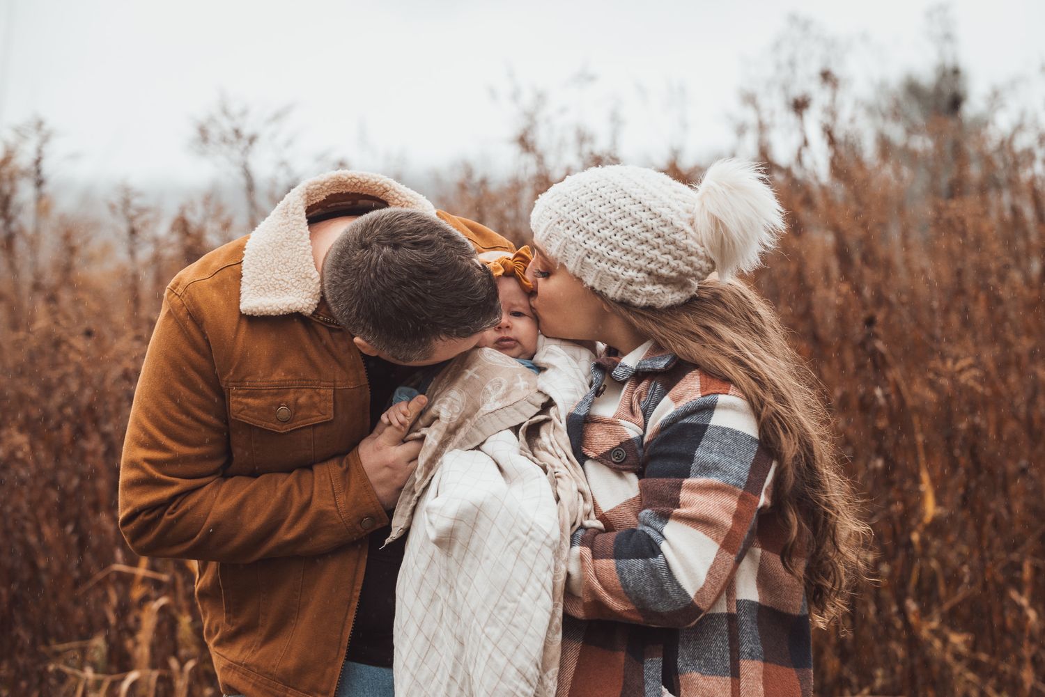 A couple shares a tender moment outdoors during an autumn photoshoot.
