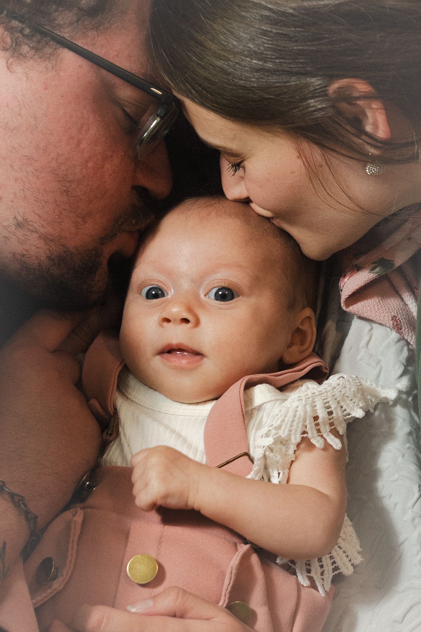 Intimate close-up moments shared with a baby wearing a delicate lace shirt.