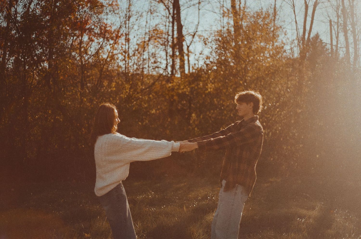 A series of six sepia-toned photos showing silhouettes dancing in a forest at sunset.