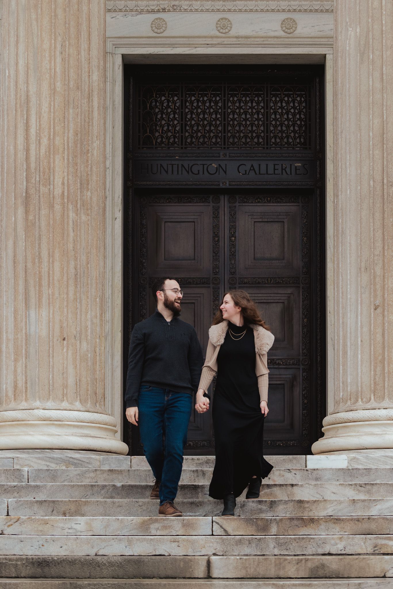 Couple standing in front of Huntington Gallery entrance doors.