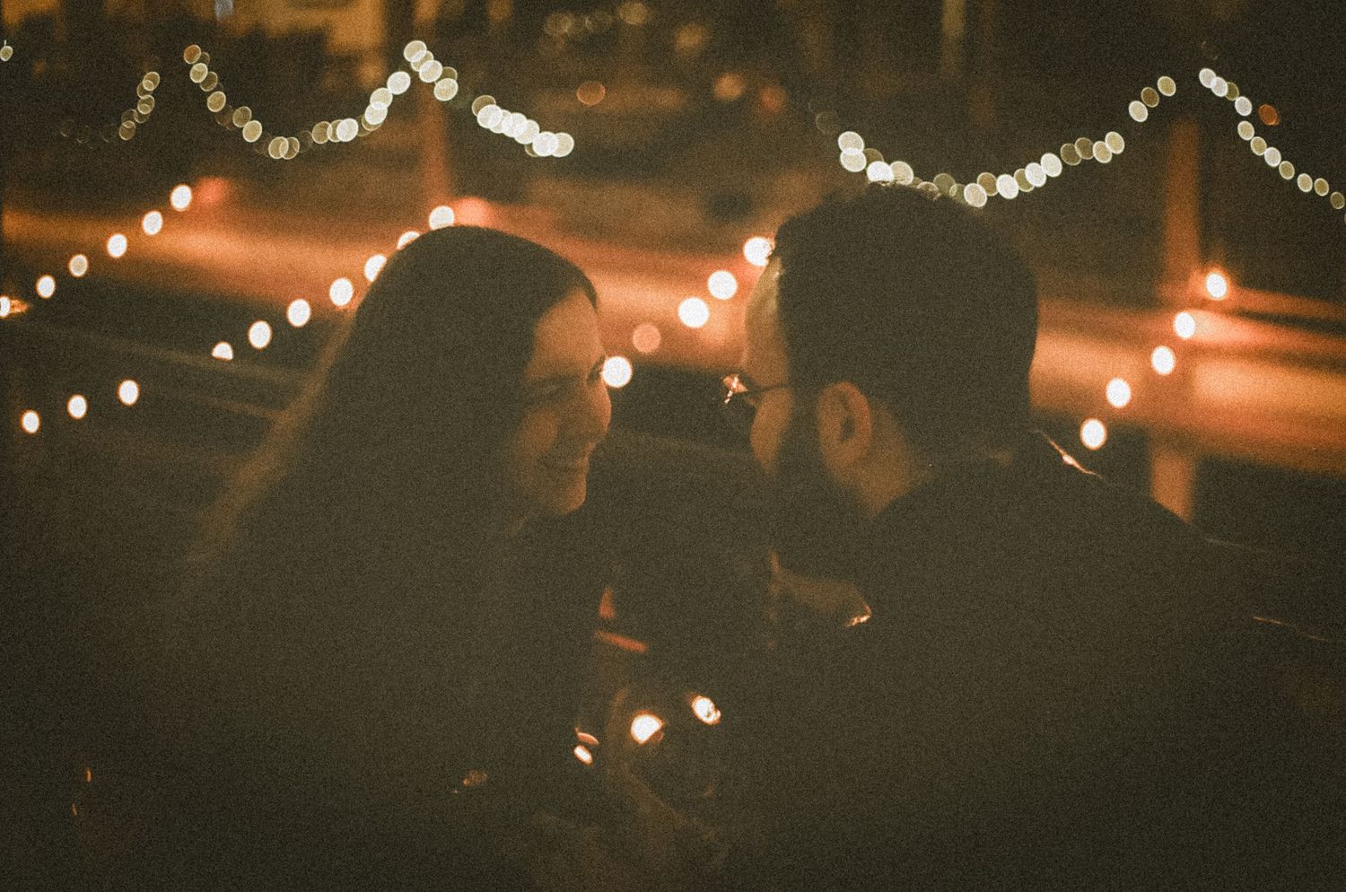 String lights illuminate a dark outdoor space creating a warm and festive atmosphere at night.
