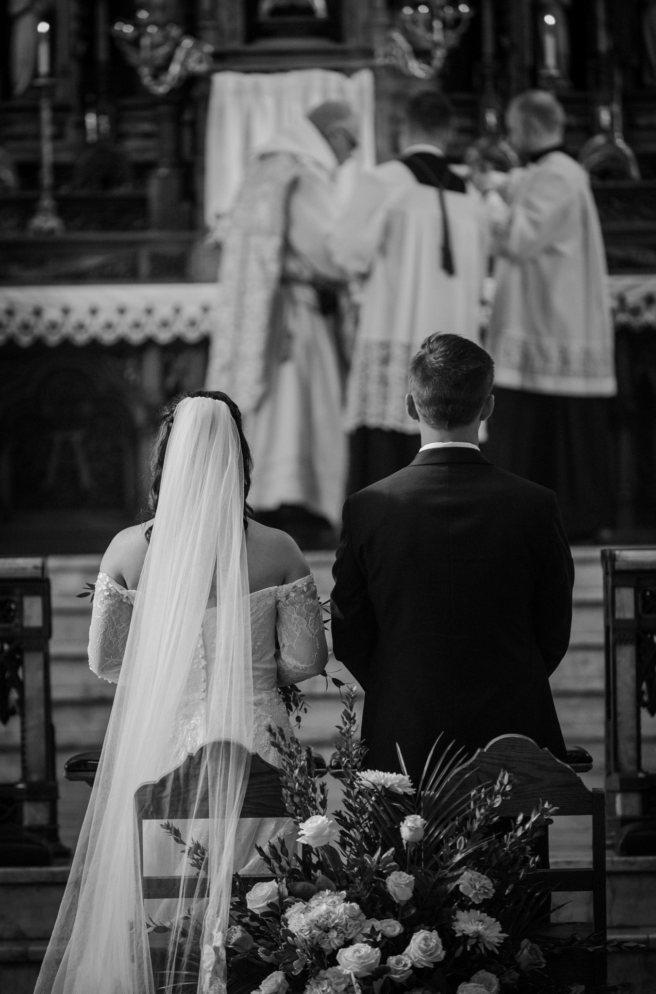 Wedding ceremony in progress at a traditional church altar.