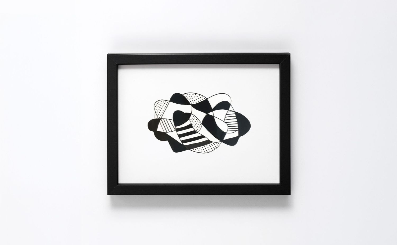 Black framed abstract art print featuring geometric black and white patterns with stairs and cloud-like shapes.