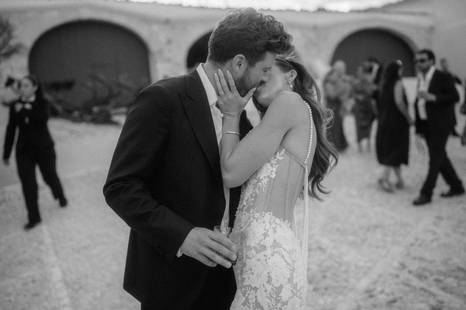 Black and white photo of bride and groom sharing an intimate moment at their wedding.