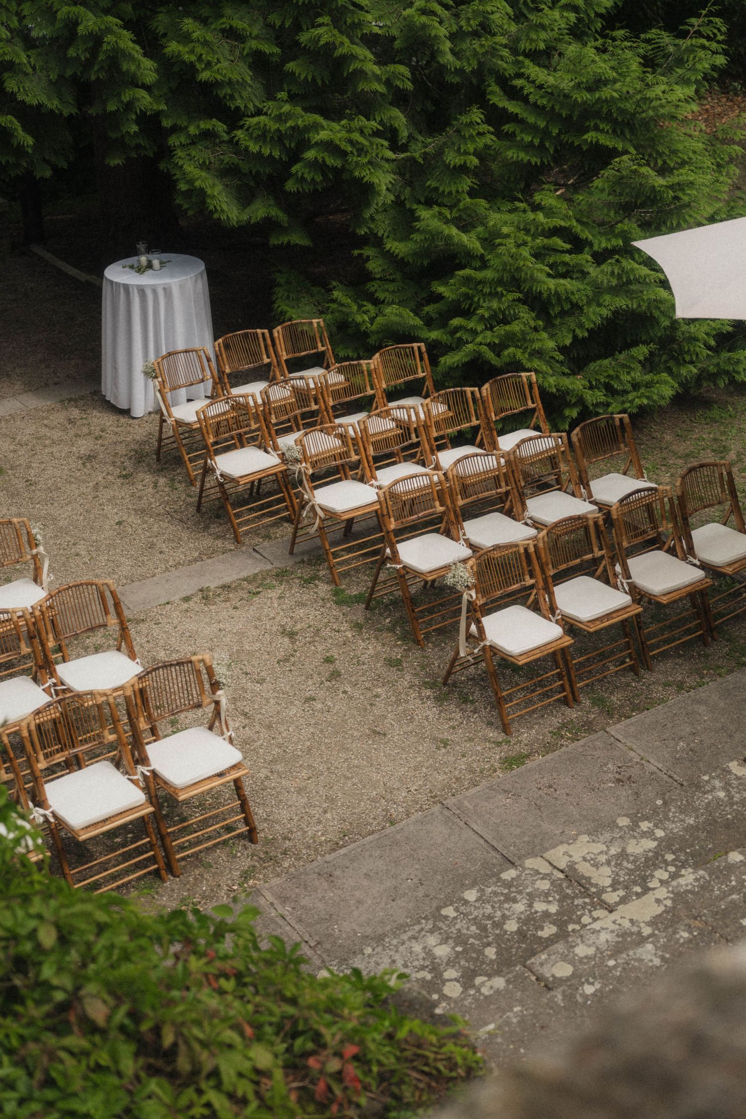 Aerial view of wooden folding chairs arranged for an outdoor wedding ceremony.
