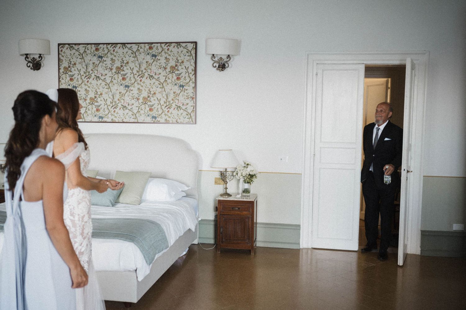Father of the bride entering room seeing his daughter in wedding dress for the first time.
