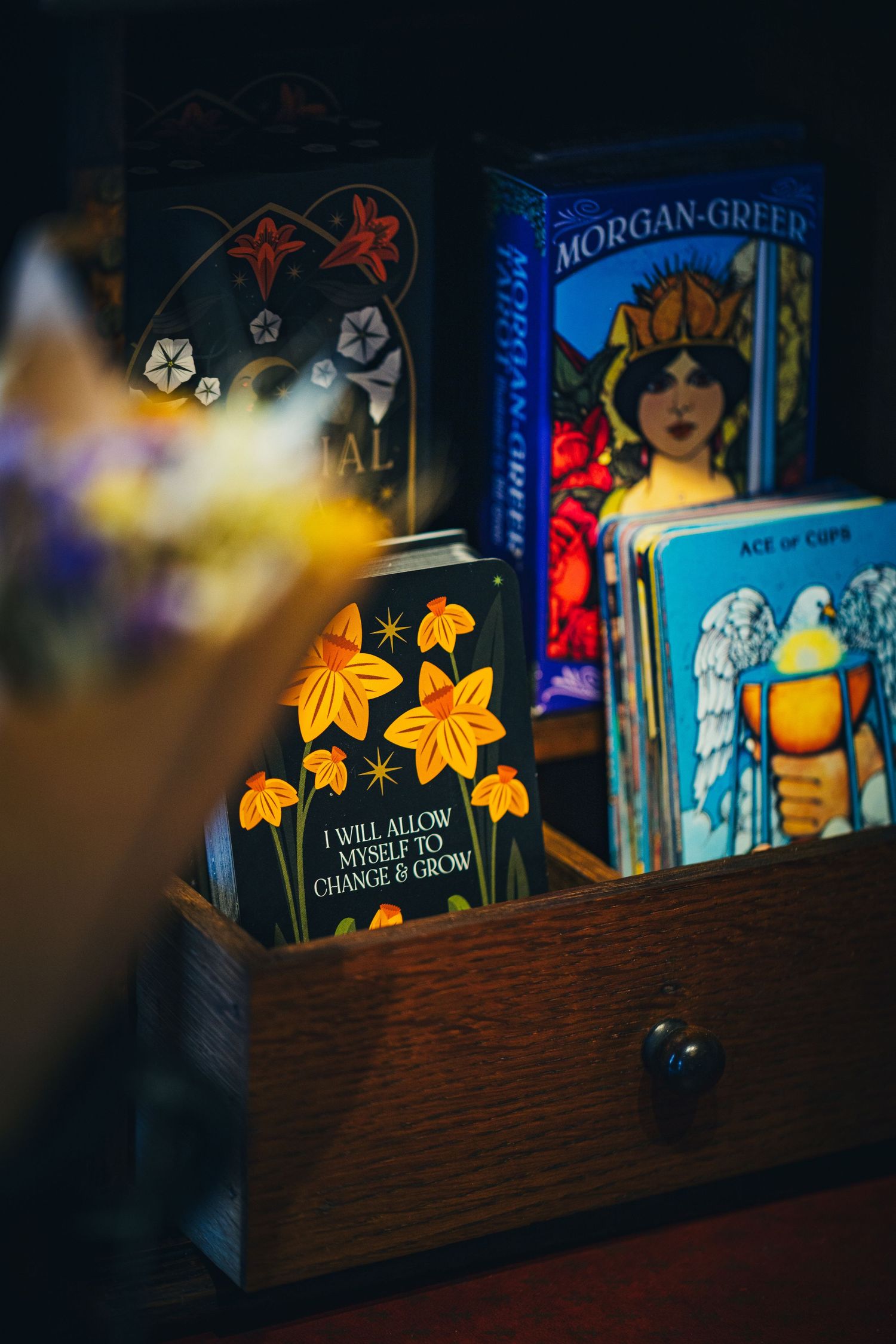 Wooden drawer display with Morgan-Greer tarot cards and a motivational card reading I Will Allow Myself to Change and Grow.