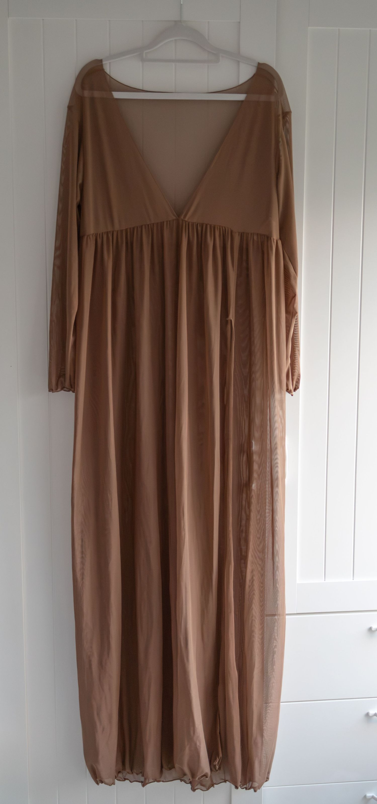 Elegant camel beige maxi dress with long sleeves, V-neckline, empire waist, and flowing sheer skirt. Taken by Golden Hour Perth