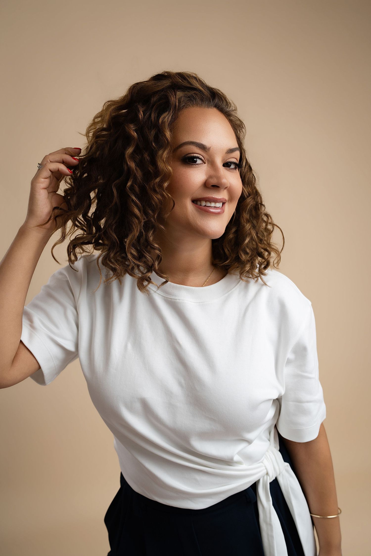 woman on tan backdrop. Best maternity and newborn photographers in Los Angeles, serving Woodland Hills.
